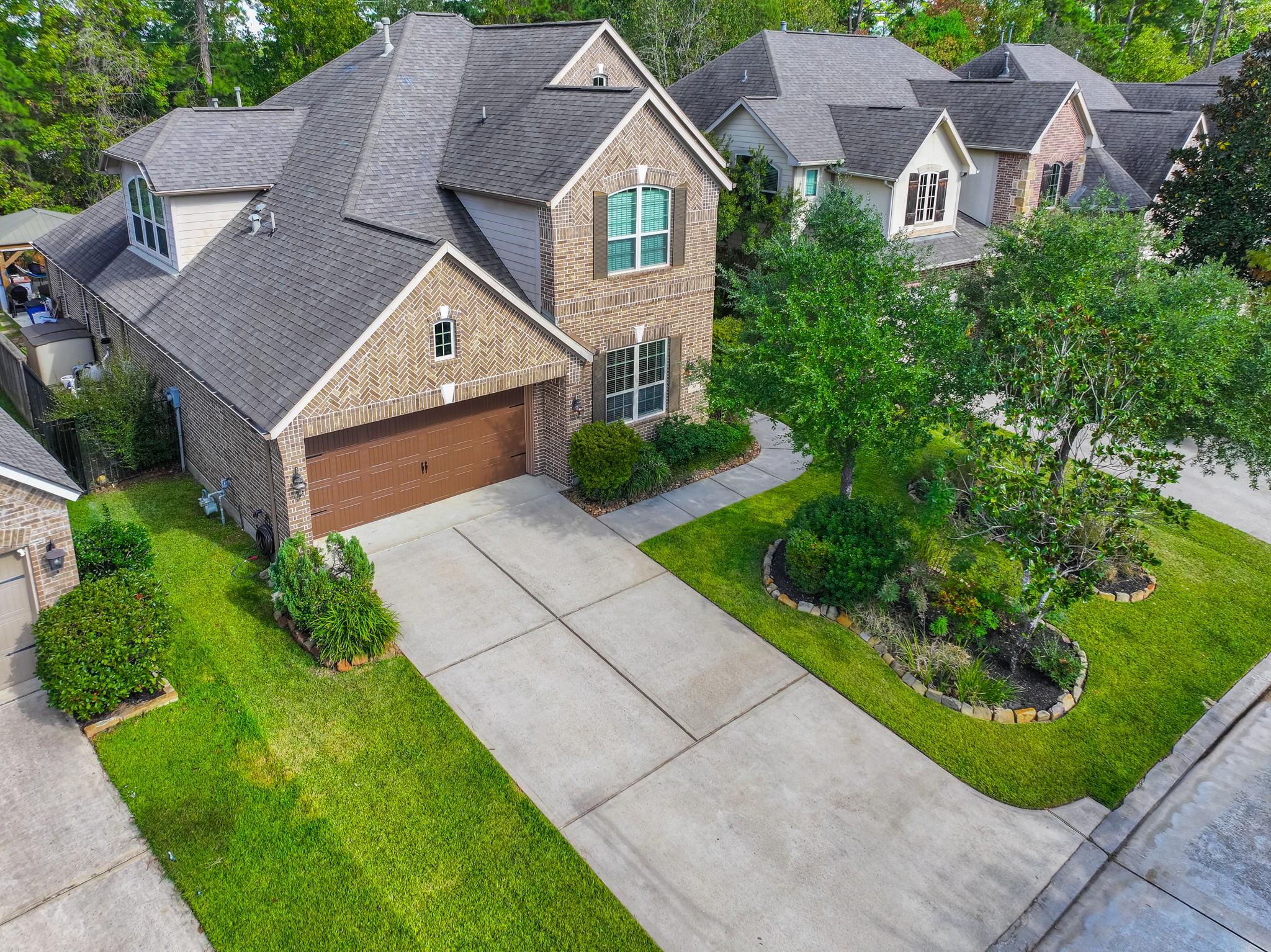 Image 2: This photo shows a charming two-story brick home w