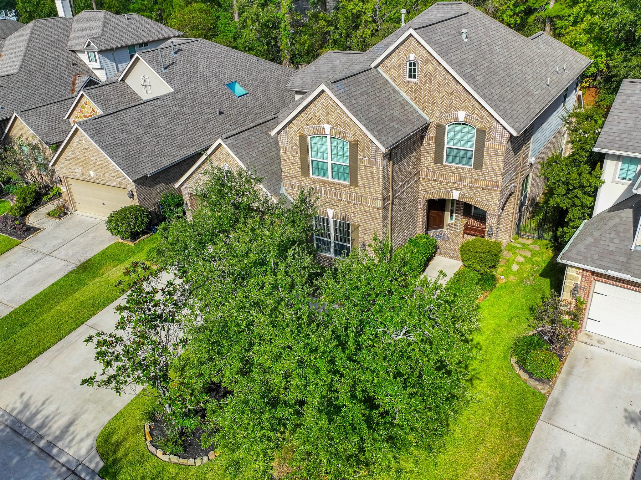 Image 3: This inviting two-story brick home features a well