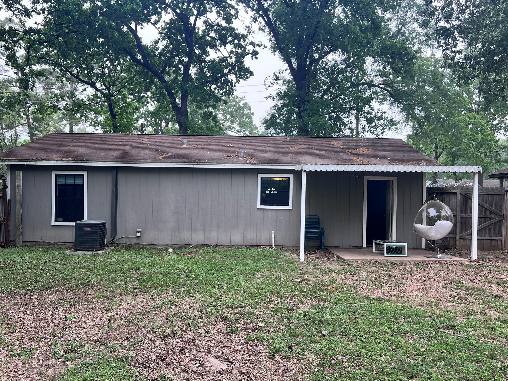 Image 4: Back of house showing covered patio on the right.