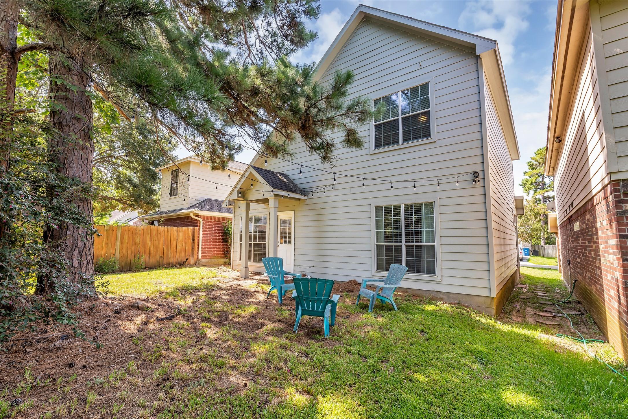 Image 4: View of the backyard retreat with lush greenery, c