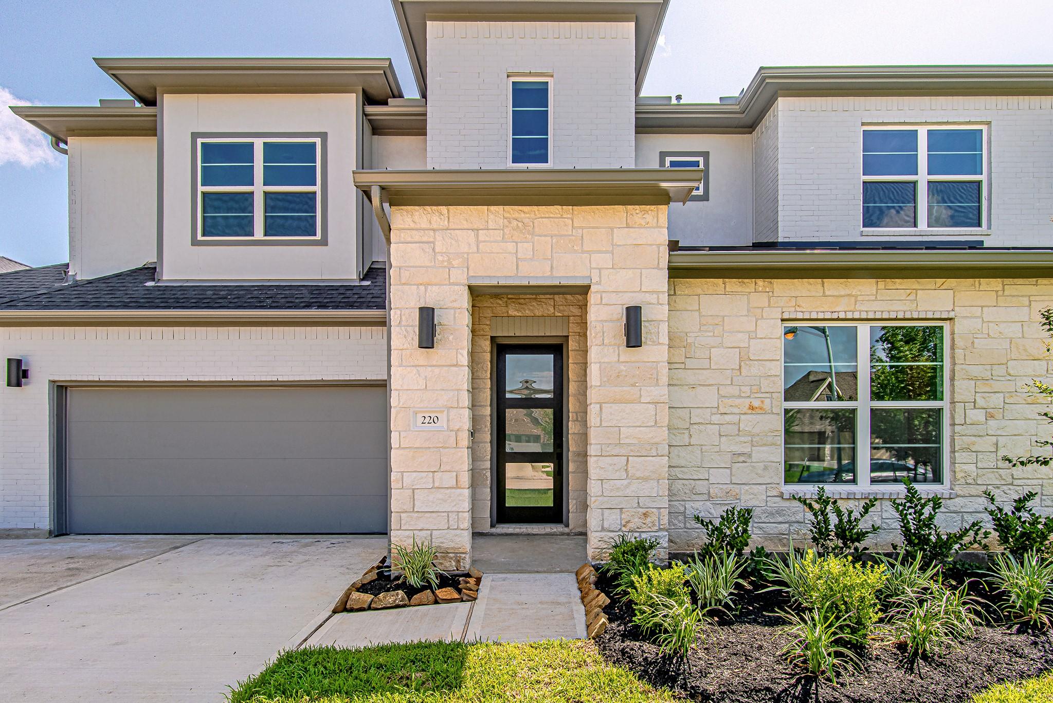 Image 3: Welcoming front entry with contemporary exterior f