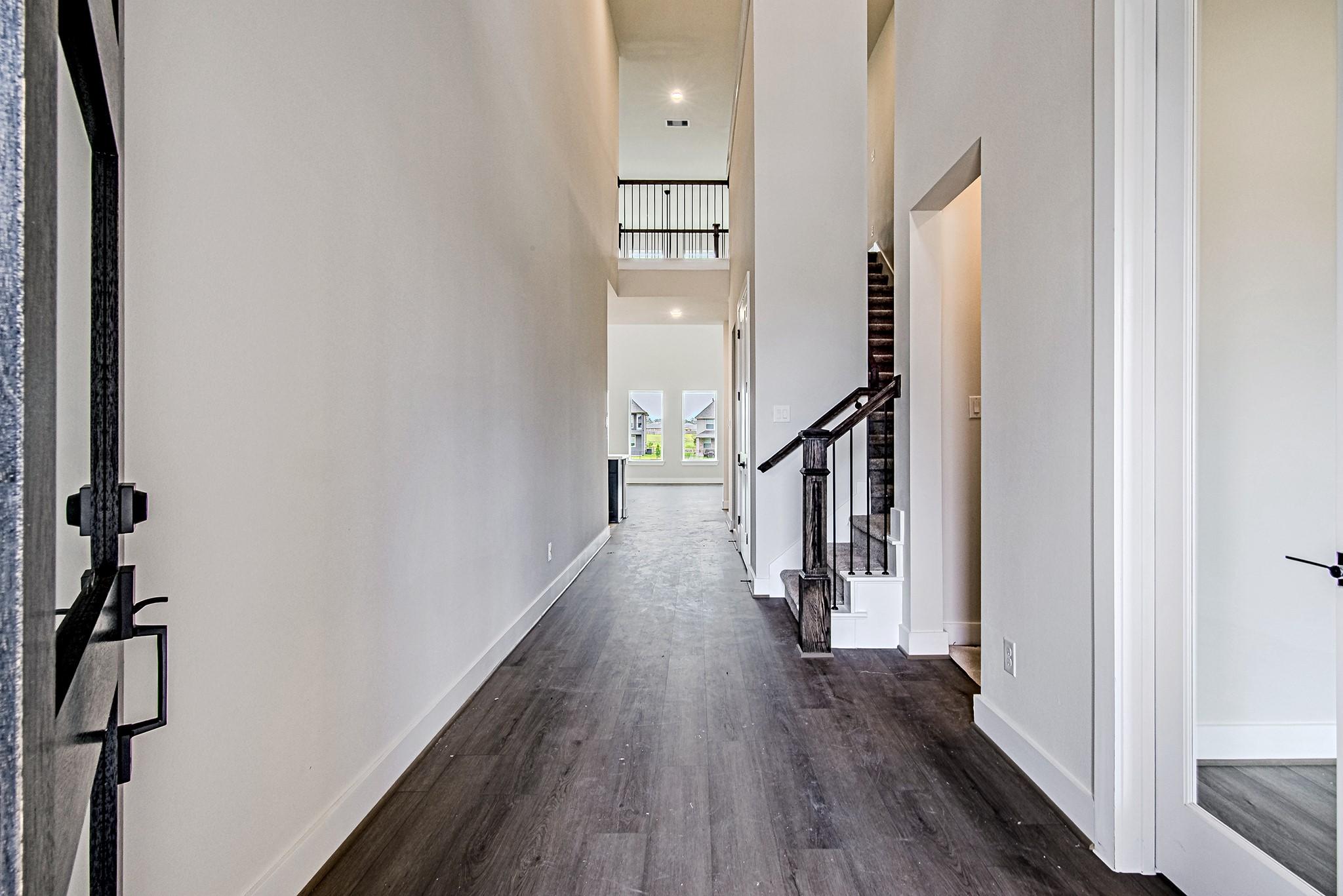 Image 4: Bright foyer with soaring ceilings and elegant flo