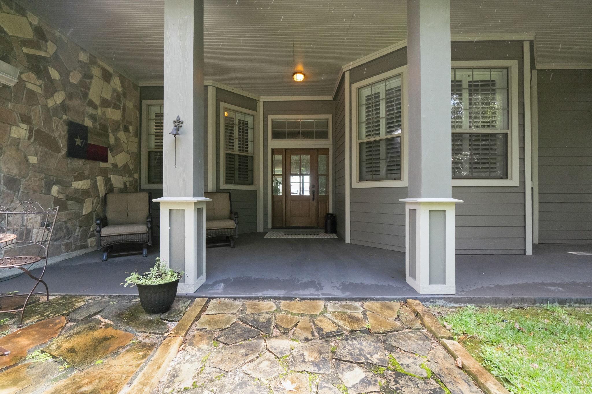 Image 2: Charming front porch with stone accents and comfor