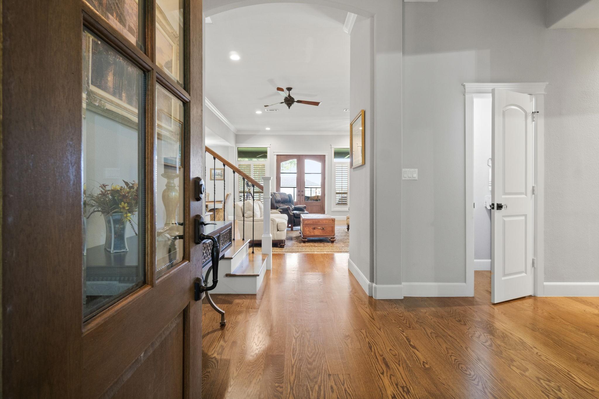 Image 4: This inviting entryway features warm wood flooring
