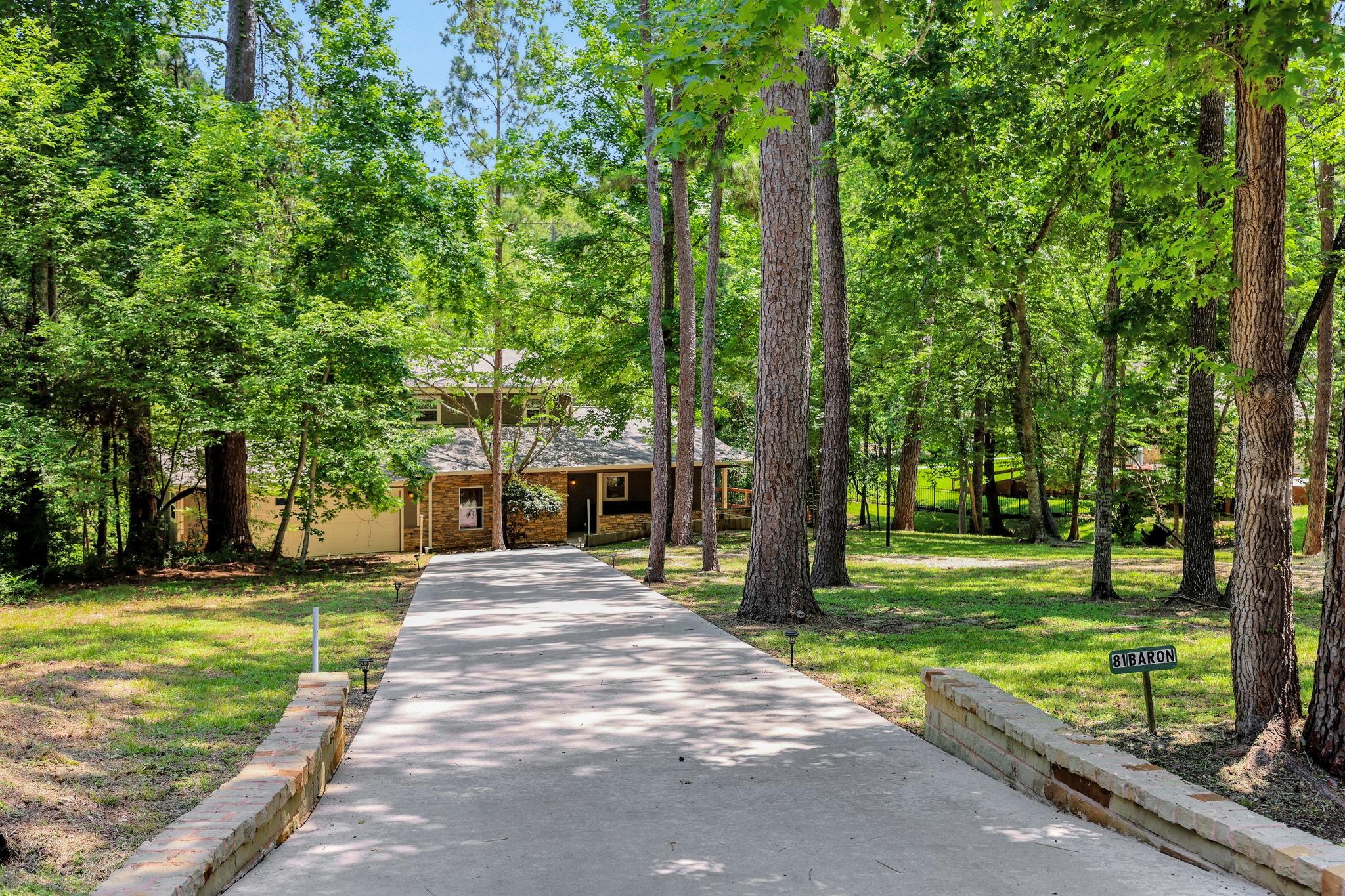 Image 4: The home sits back on the lot - the driveway provi