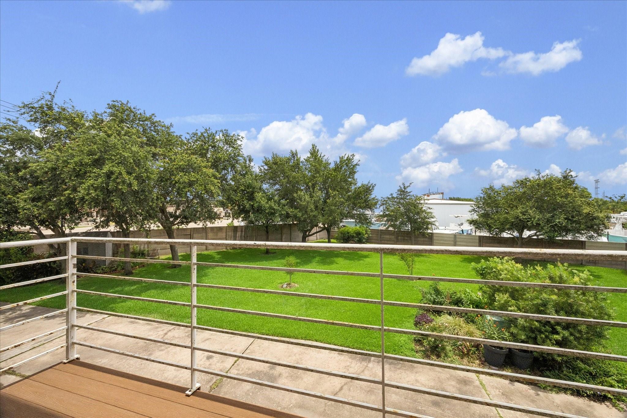 Image 4: The rear balcony overlooks a large greenspace.