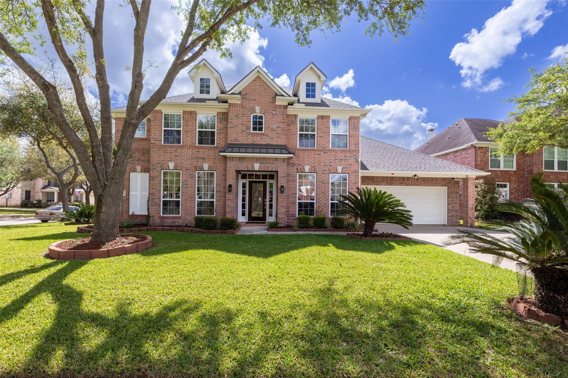 Image 2: Charming front view showcasing the home's classic