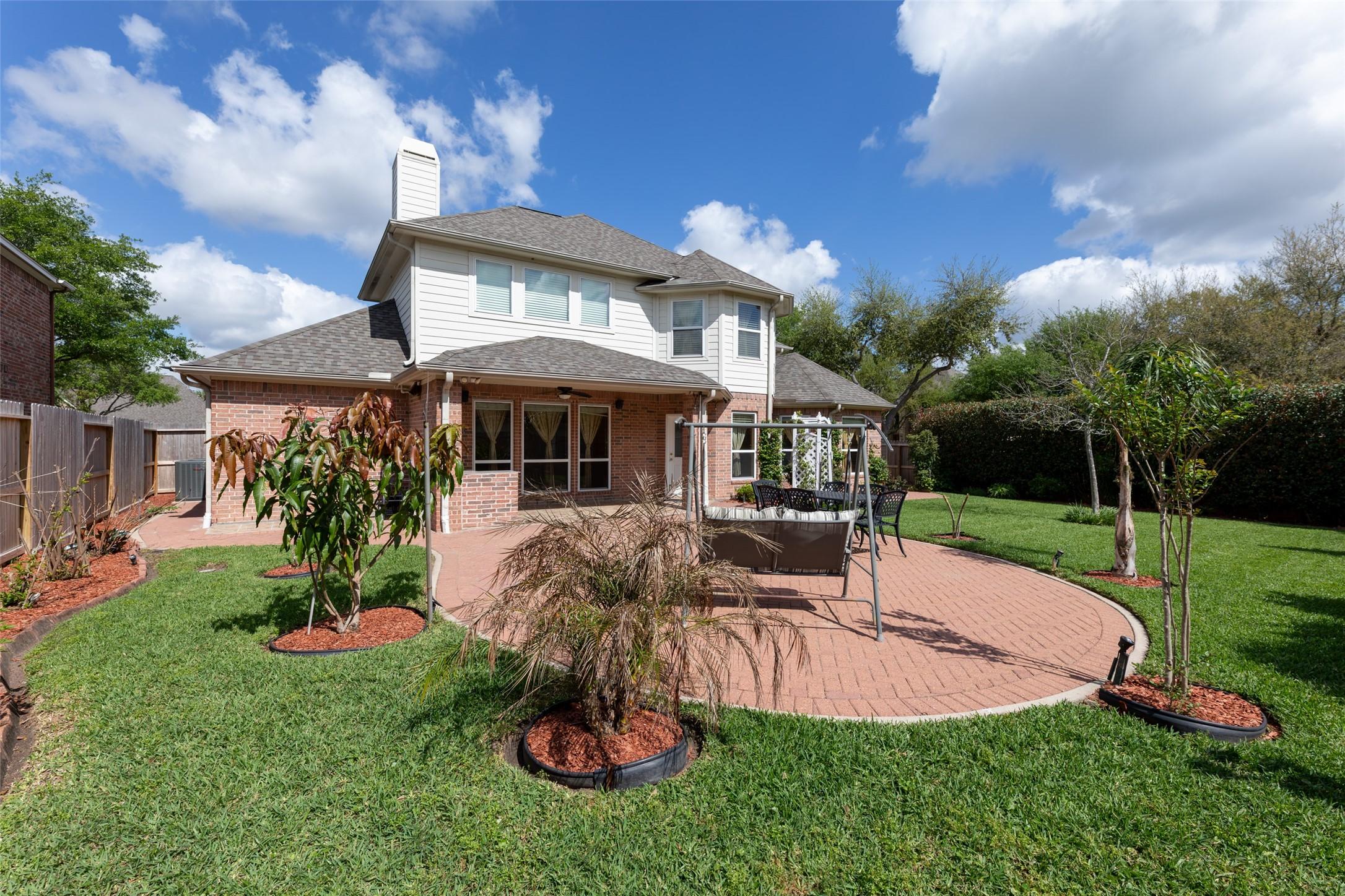 Image 4: Experience a beautifully landscaped backyard featu