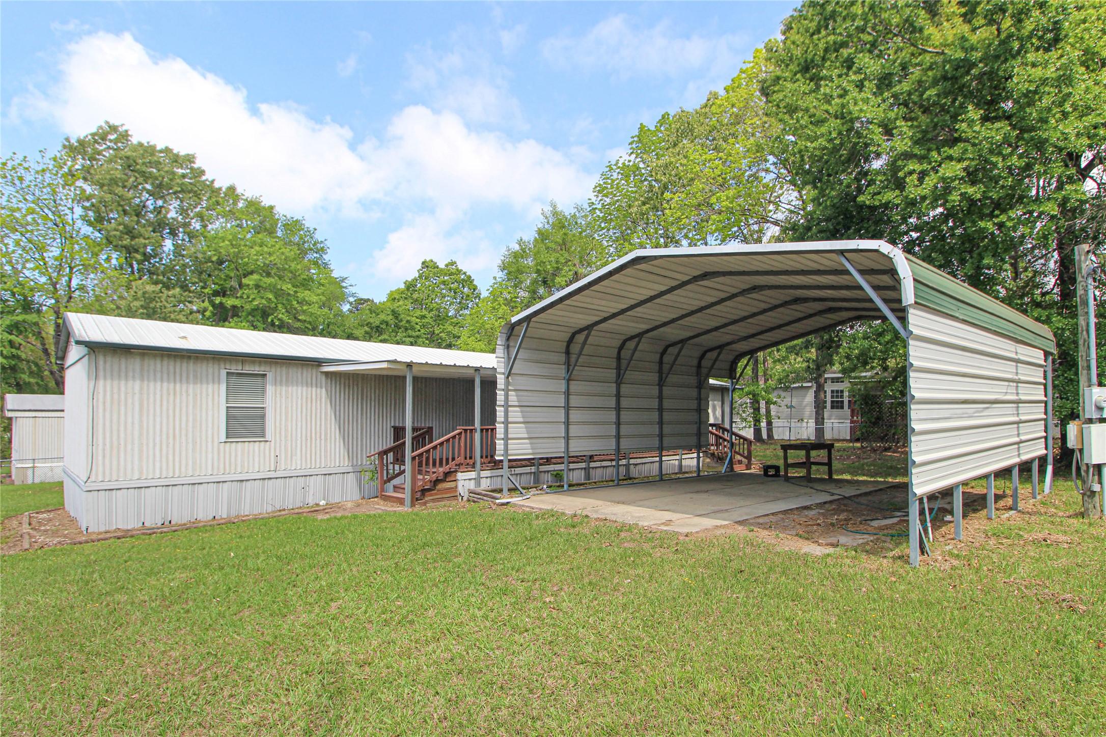 Image 4: The home features a covered porch with steps leadi