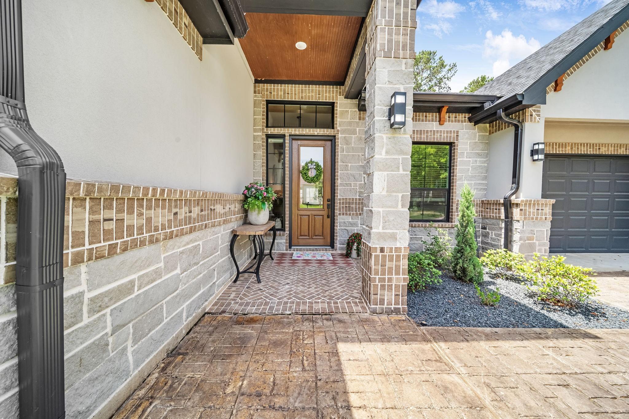 Image 4: Inviting front porch area with upgraded stamped co