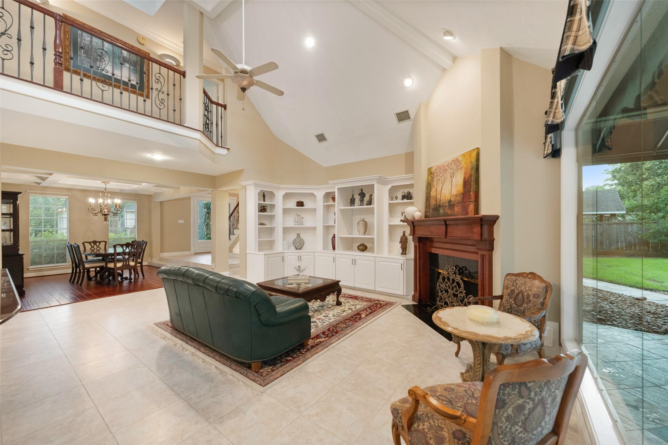 Image 4: Family room features high ceilings, a cozy firepla