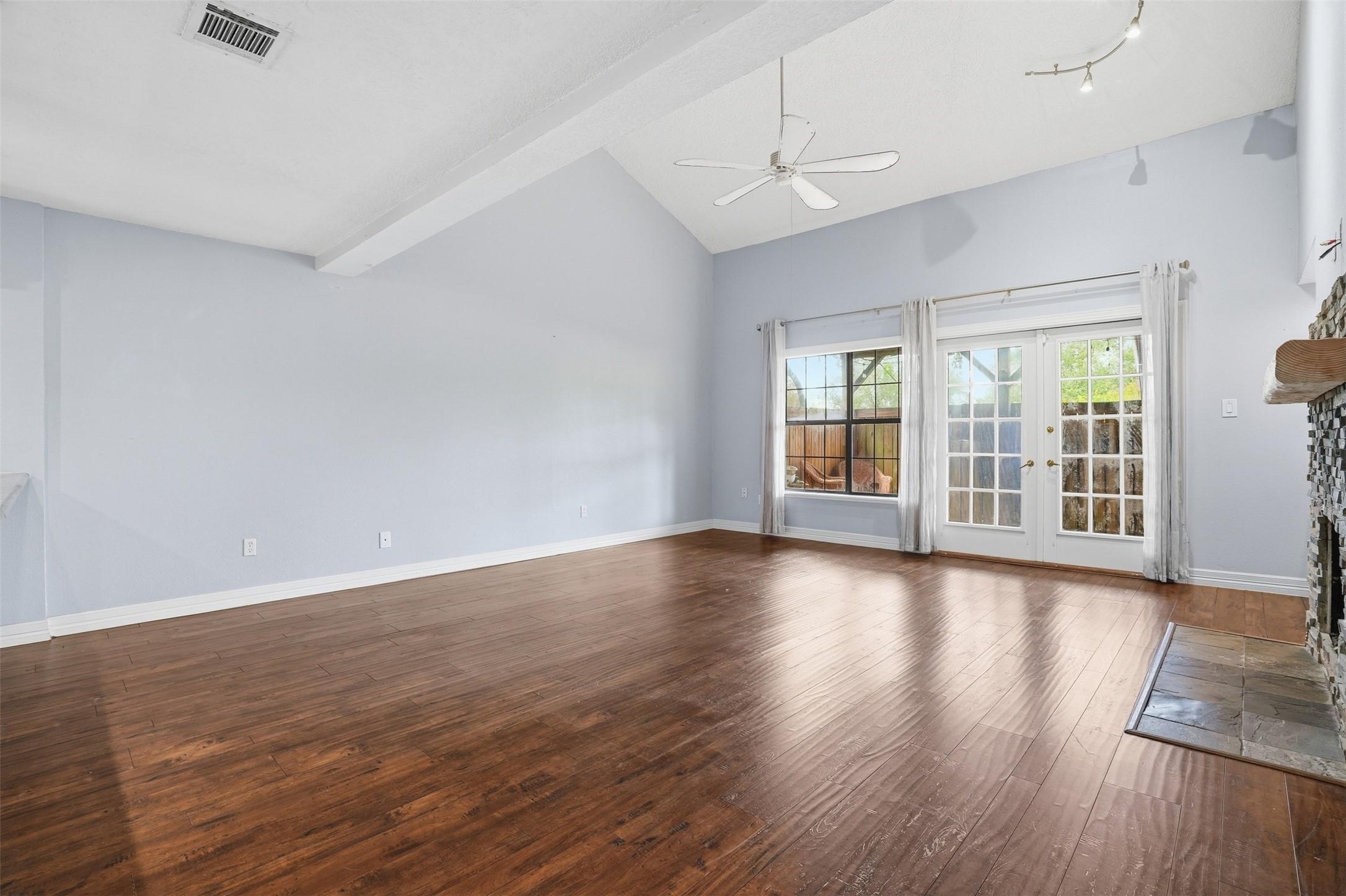 Image 4: Spacious living room featuring soaring ceilings, w