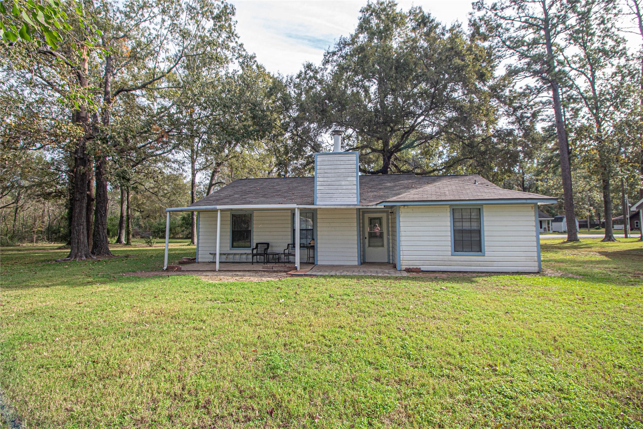 Image 4: Back of the home with a covered porch.