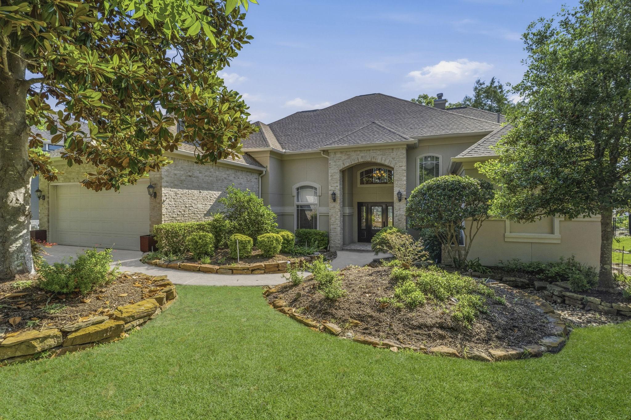 Image 1: This inviting home features a spacious front yard