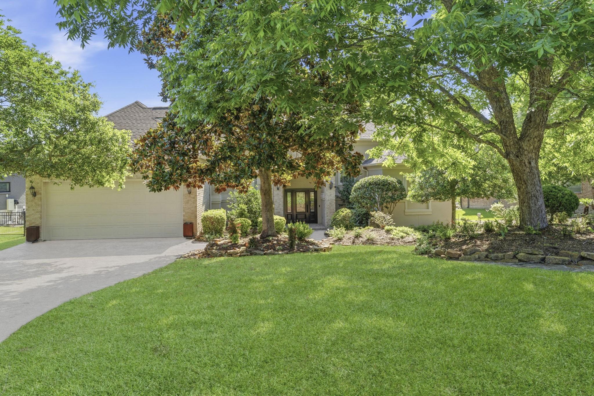 Image 2: This charming home features a well-maintained fron