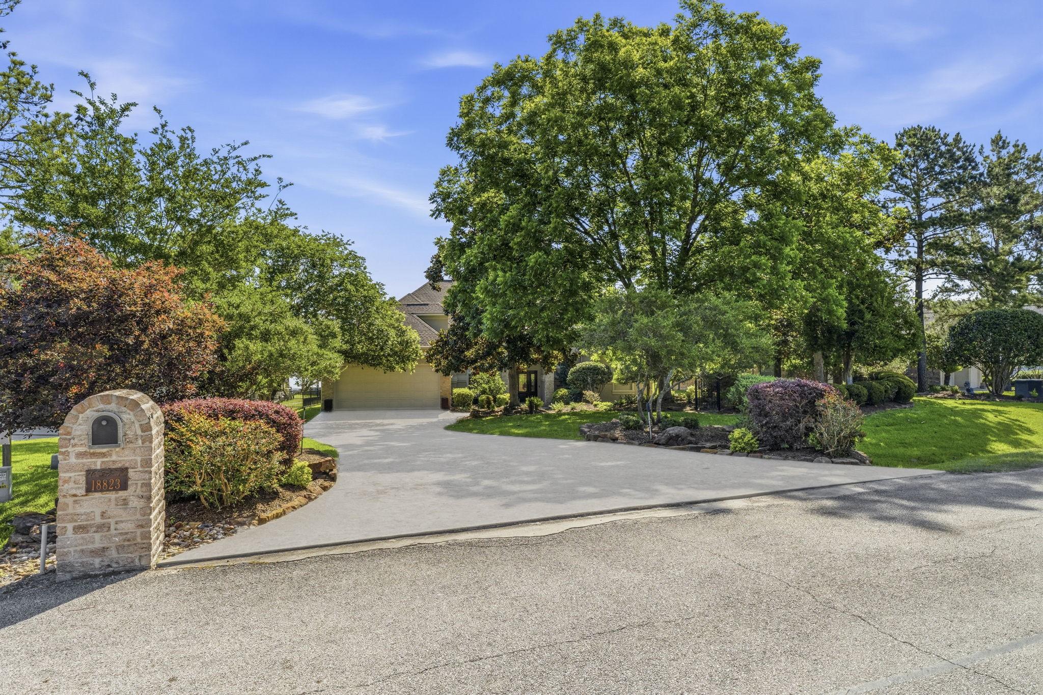 Image 4: This property features a spacious driveway leading