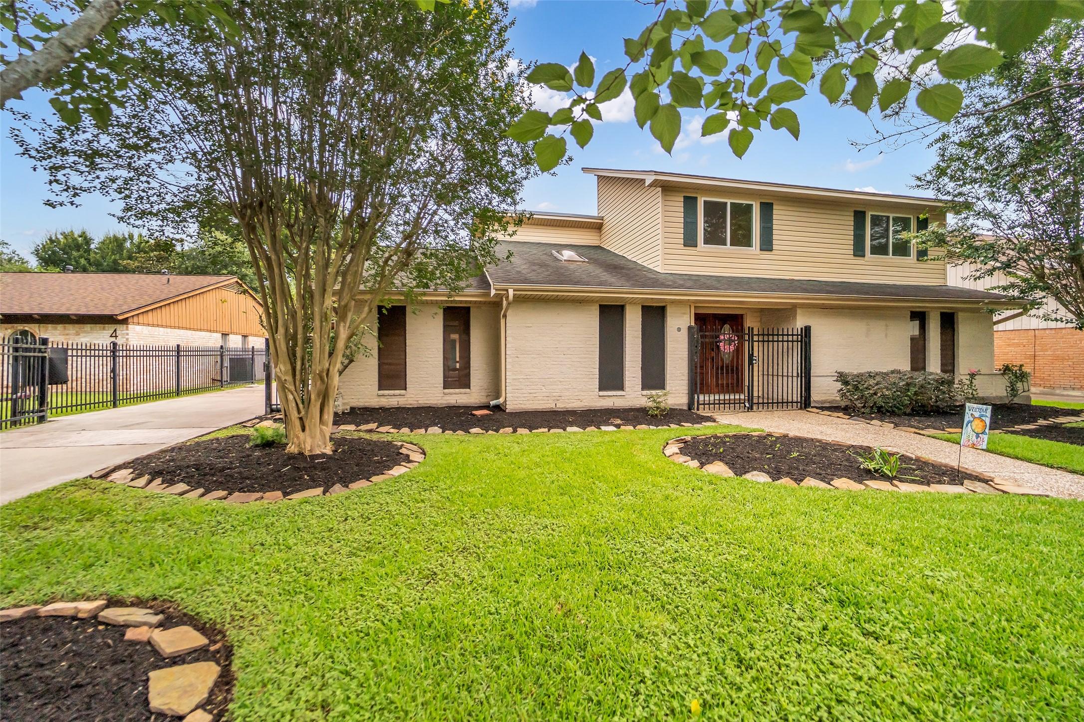 Image 3: Welcome Home! Beautiful landscaping, mature trees,