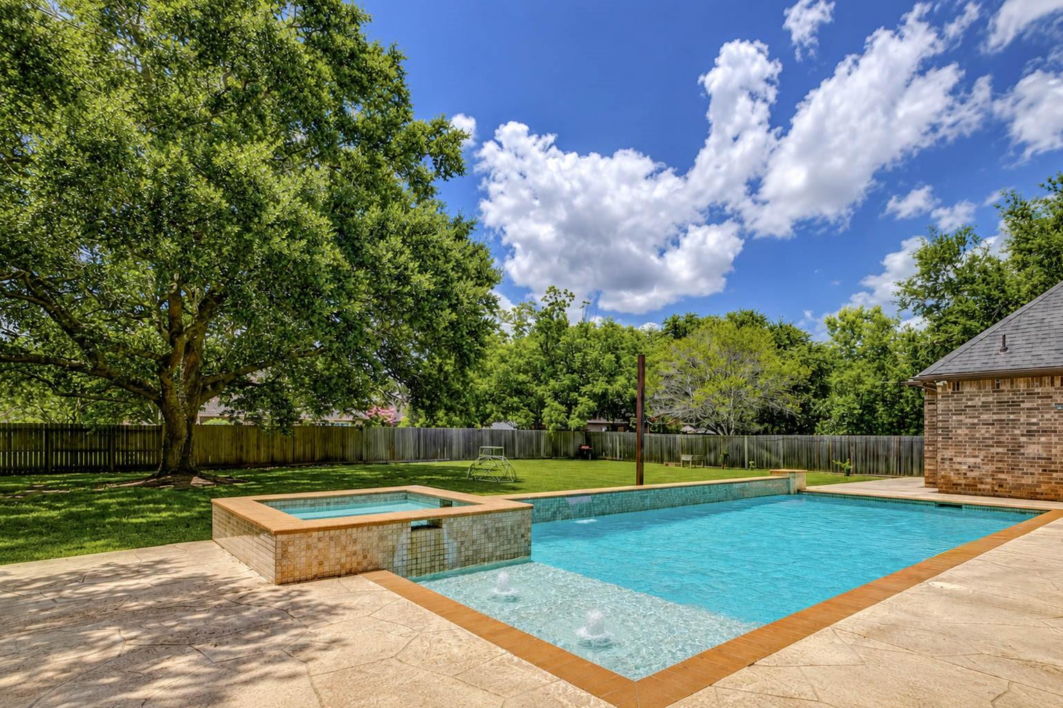 Image 3: The pool's tanning ledge provides the perfect spot