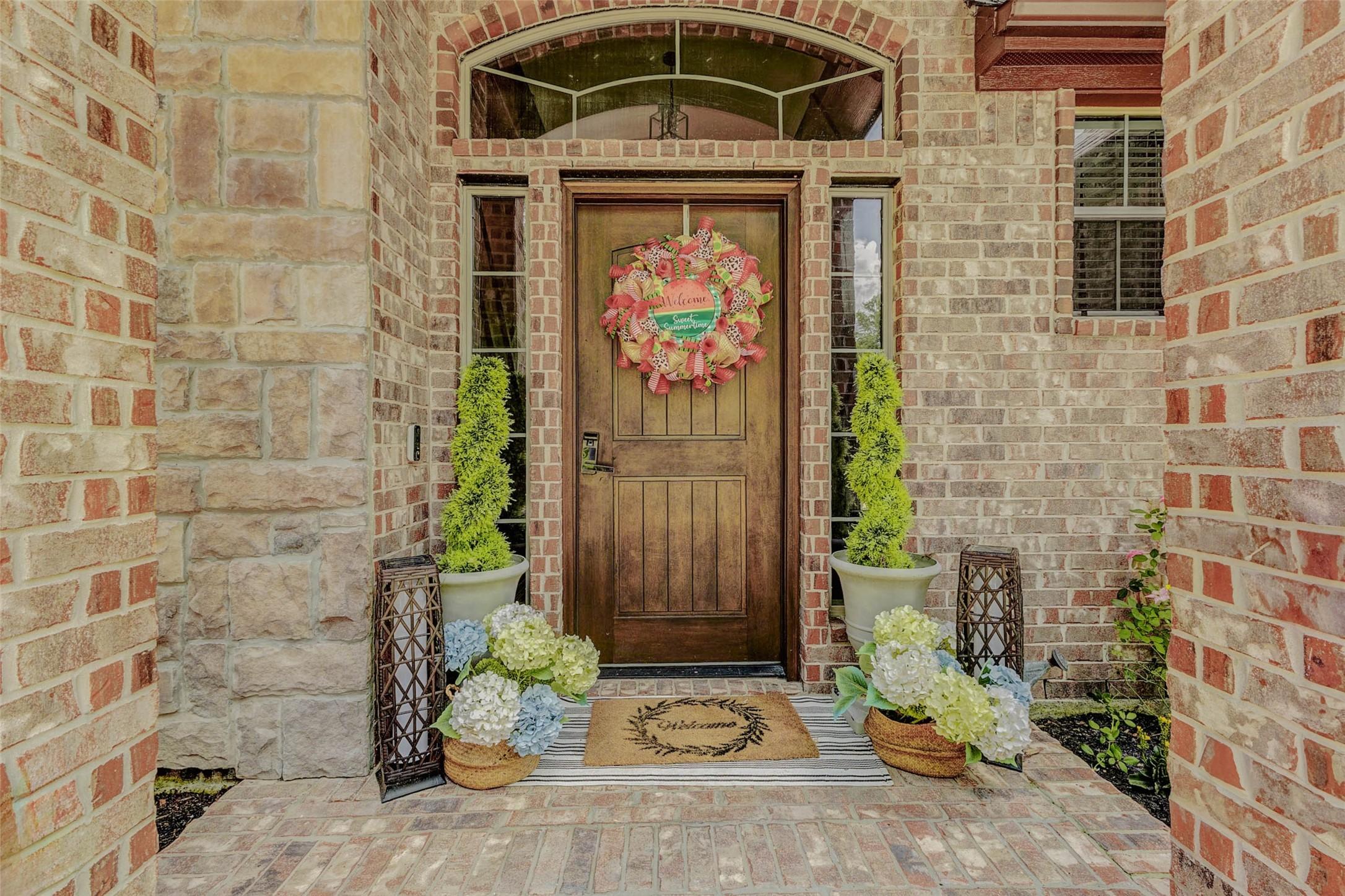 Image 4: This front entry features a charming solid wood sp