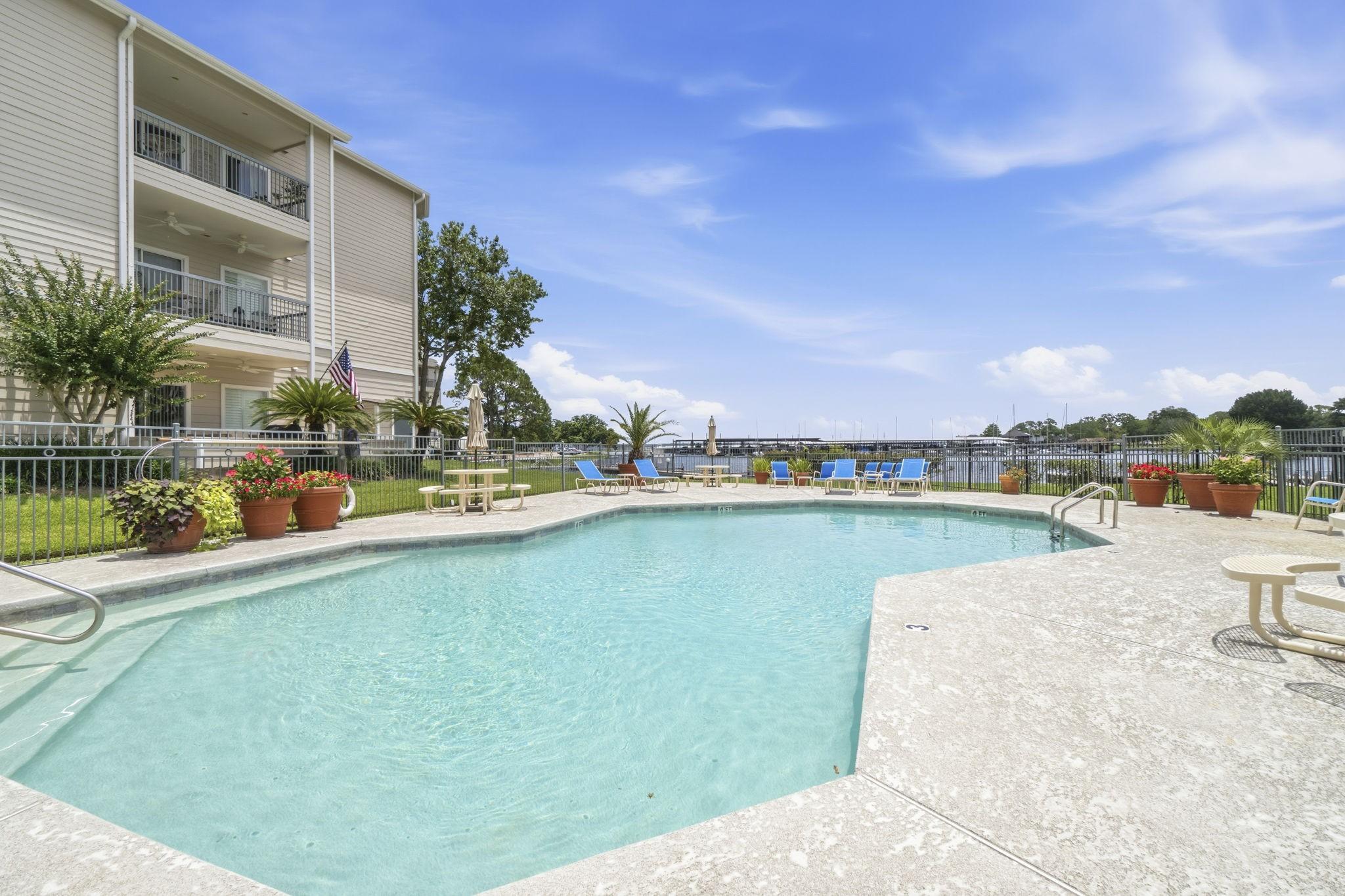 Image 4: Relax and unwind at the sparkling waterfront pool