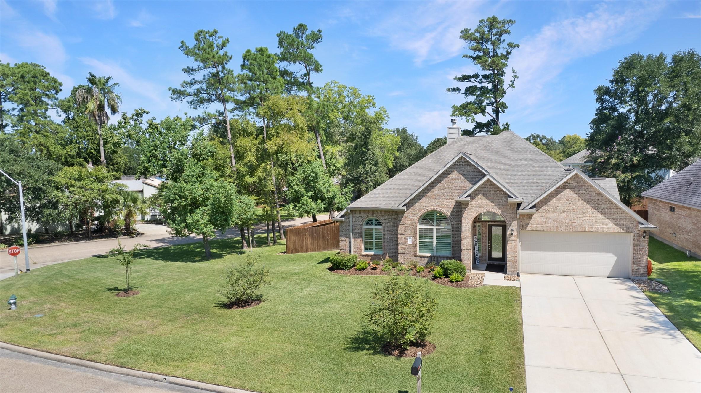 Image 2: It enjoys all the green space of a corner lot.