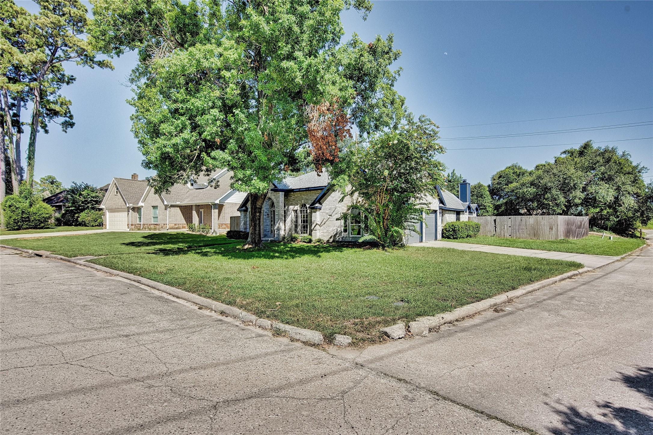 Image 3: Expansive corner lot offering abundant space and p