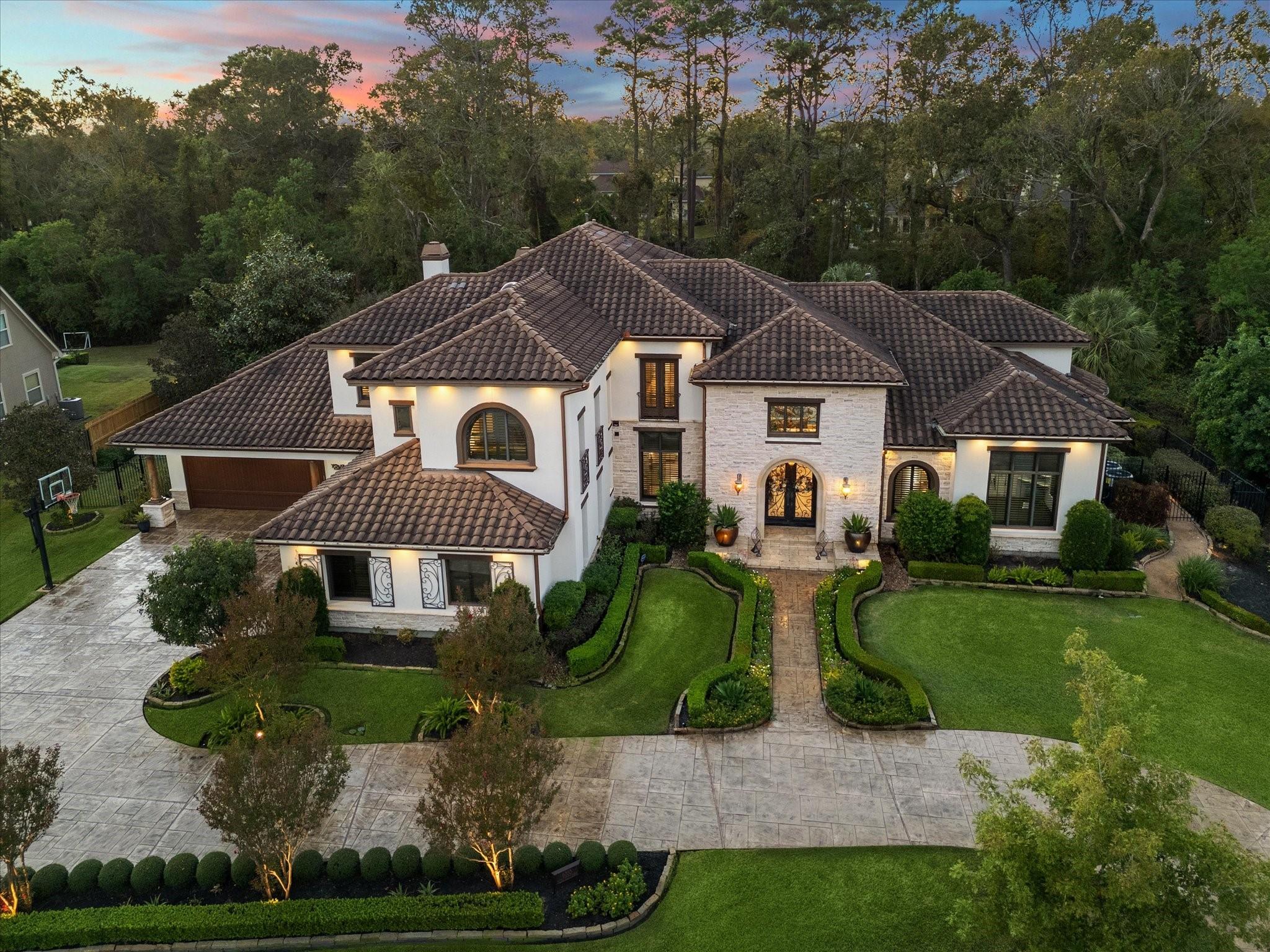 Image 1: This is a luxurious two-story home with a well-man