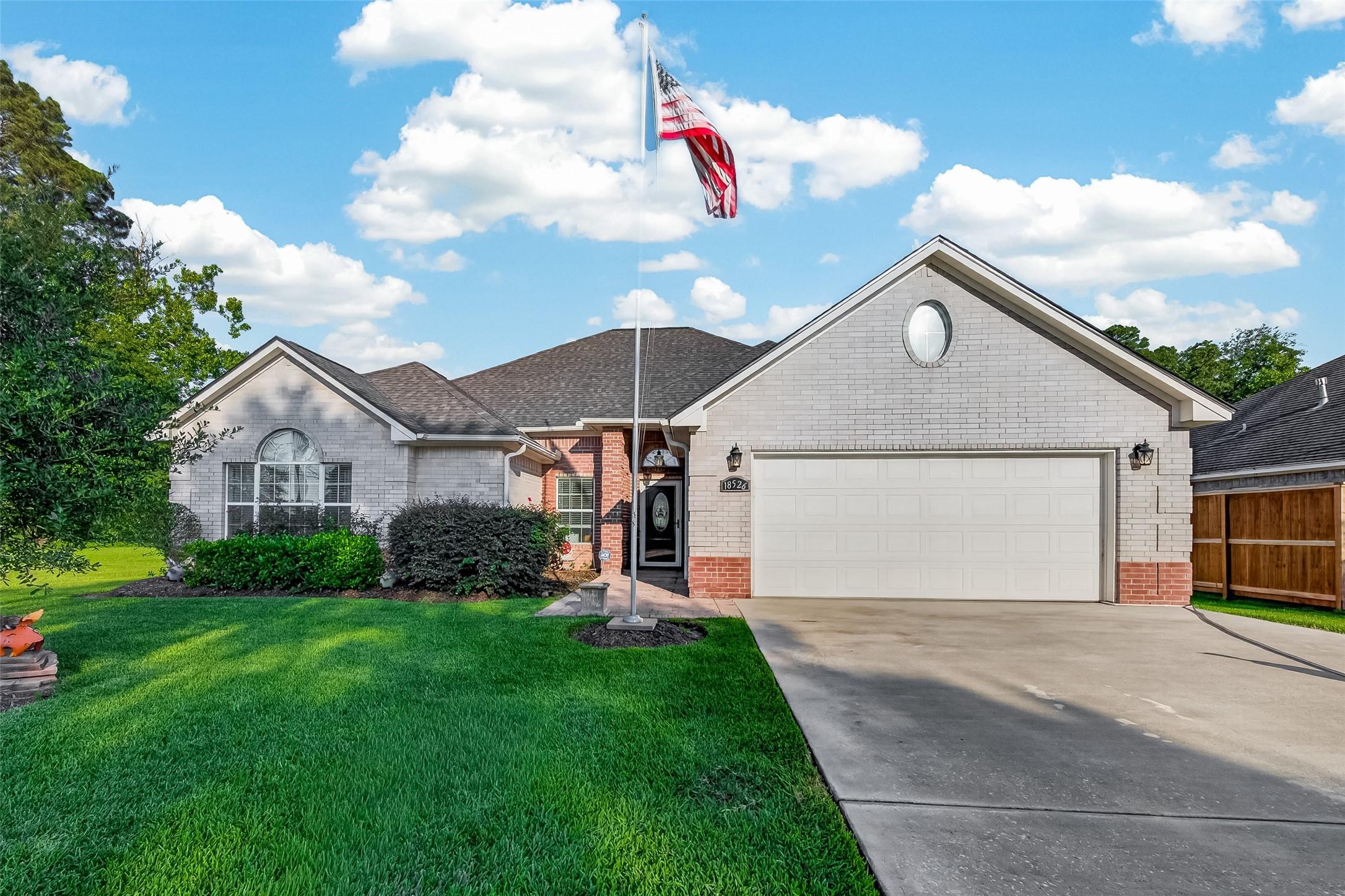 Image 1: This charming home features a well-maintained bric