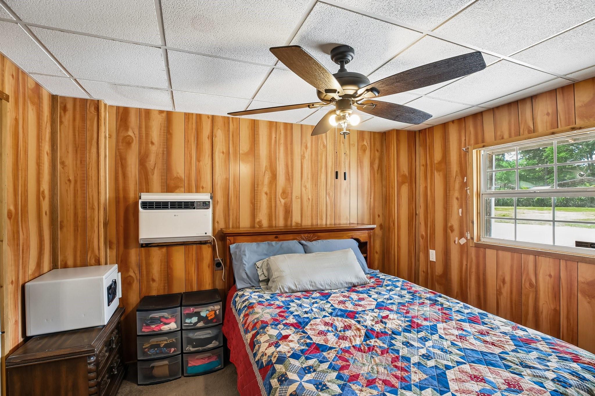 Image 3: The primary bedroom offers a warm, rustic atmosphe