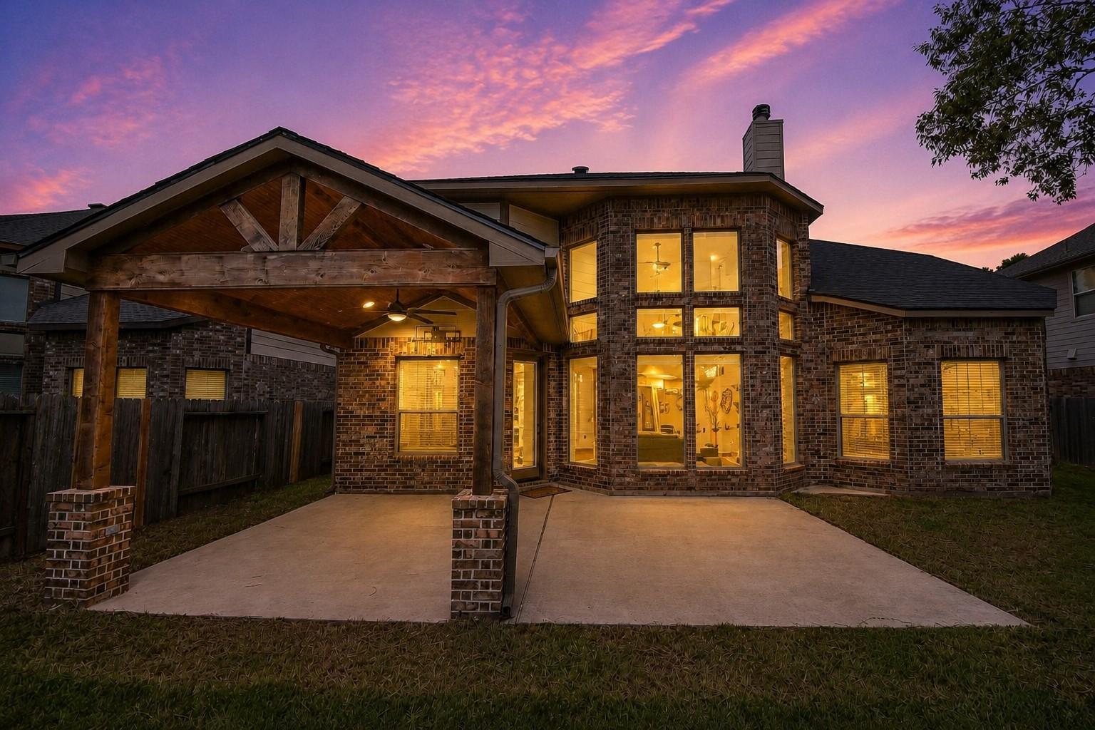 Image 2: Inviting backyard with a covered patio, offering a
