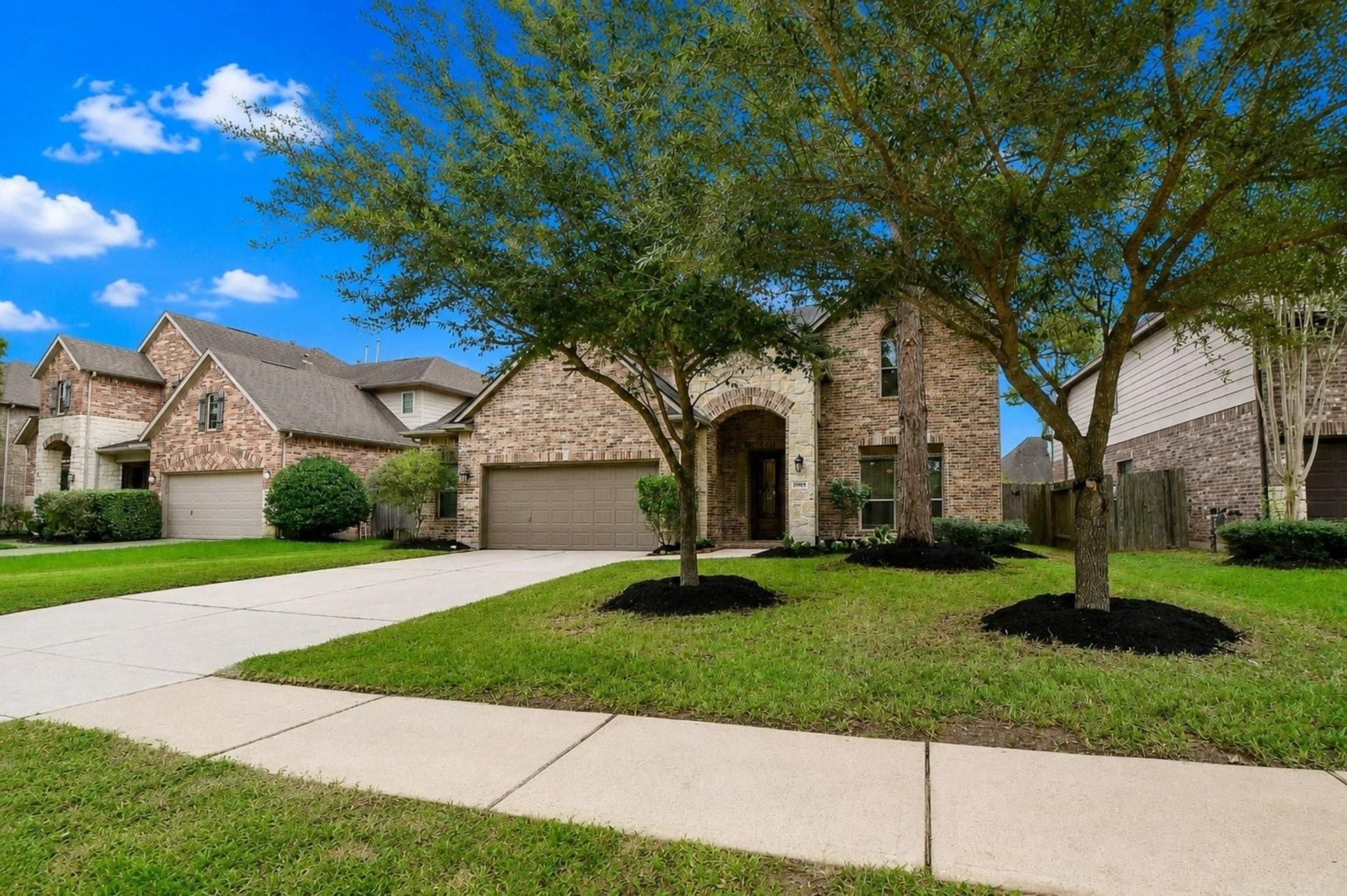 Image 3: Attractive curb appeal framed by mature trees, wit
