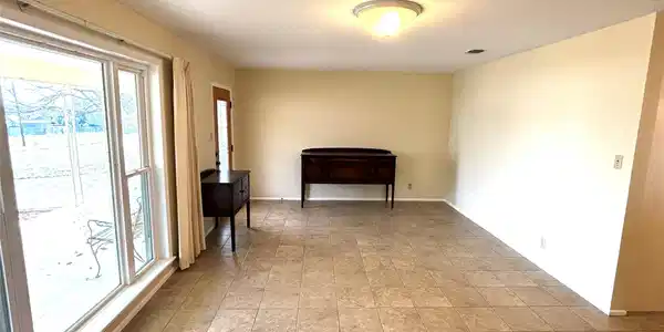 Image 2: Front Entry leading into Living Room area.