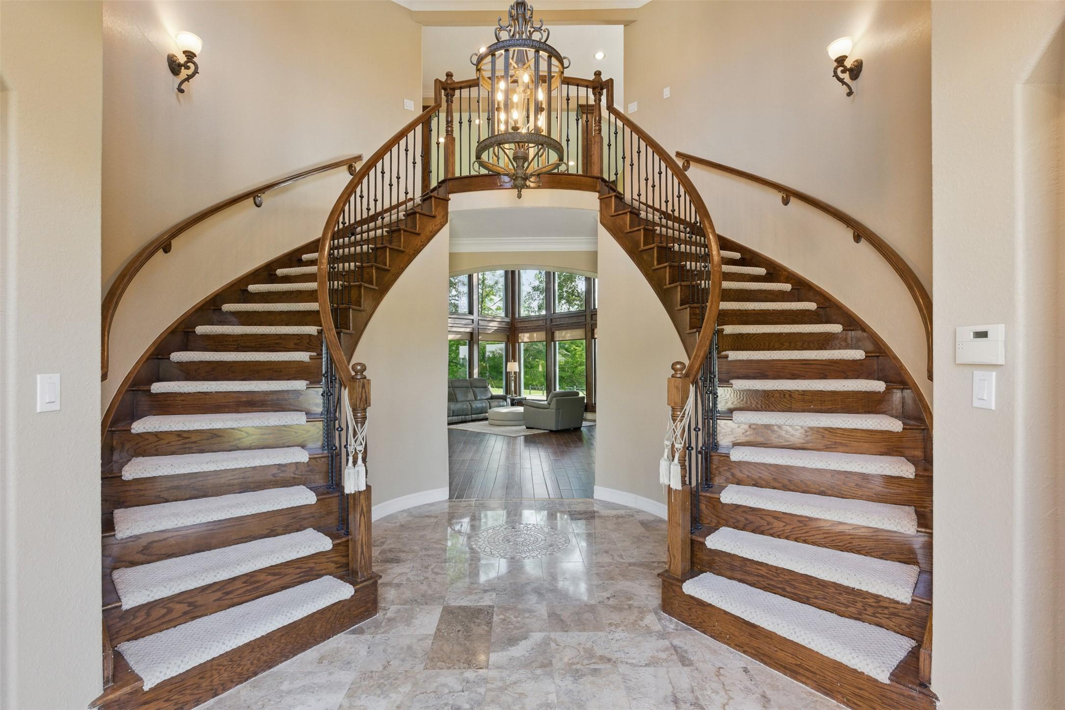 Image 2: This elegant home entry features a grand double st