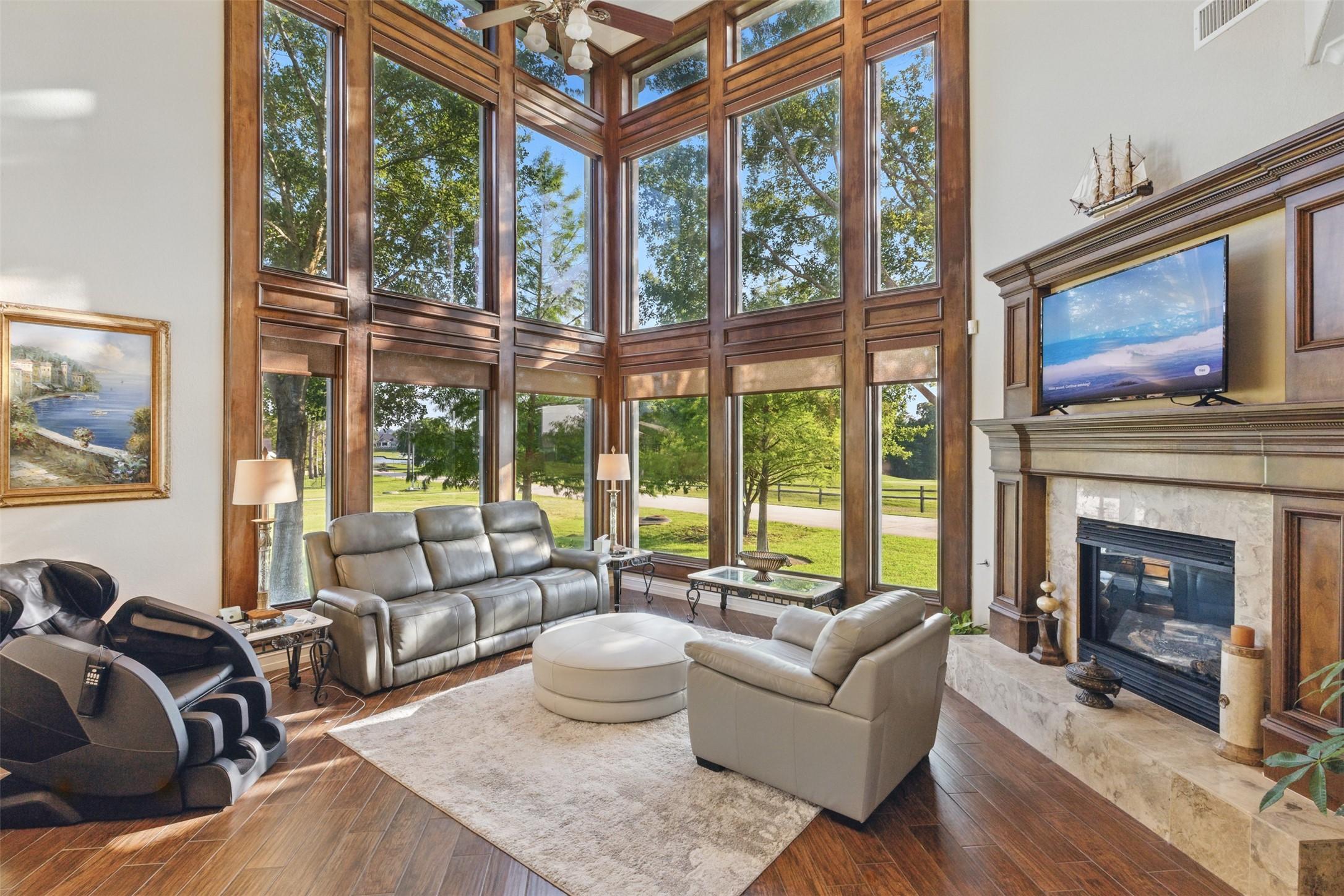 Image 4: This spacious living room features floor-to-ceilin