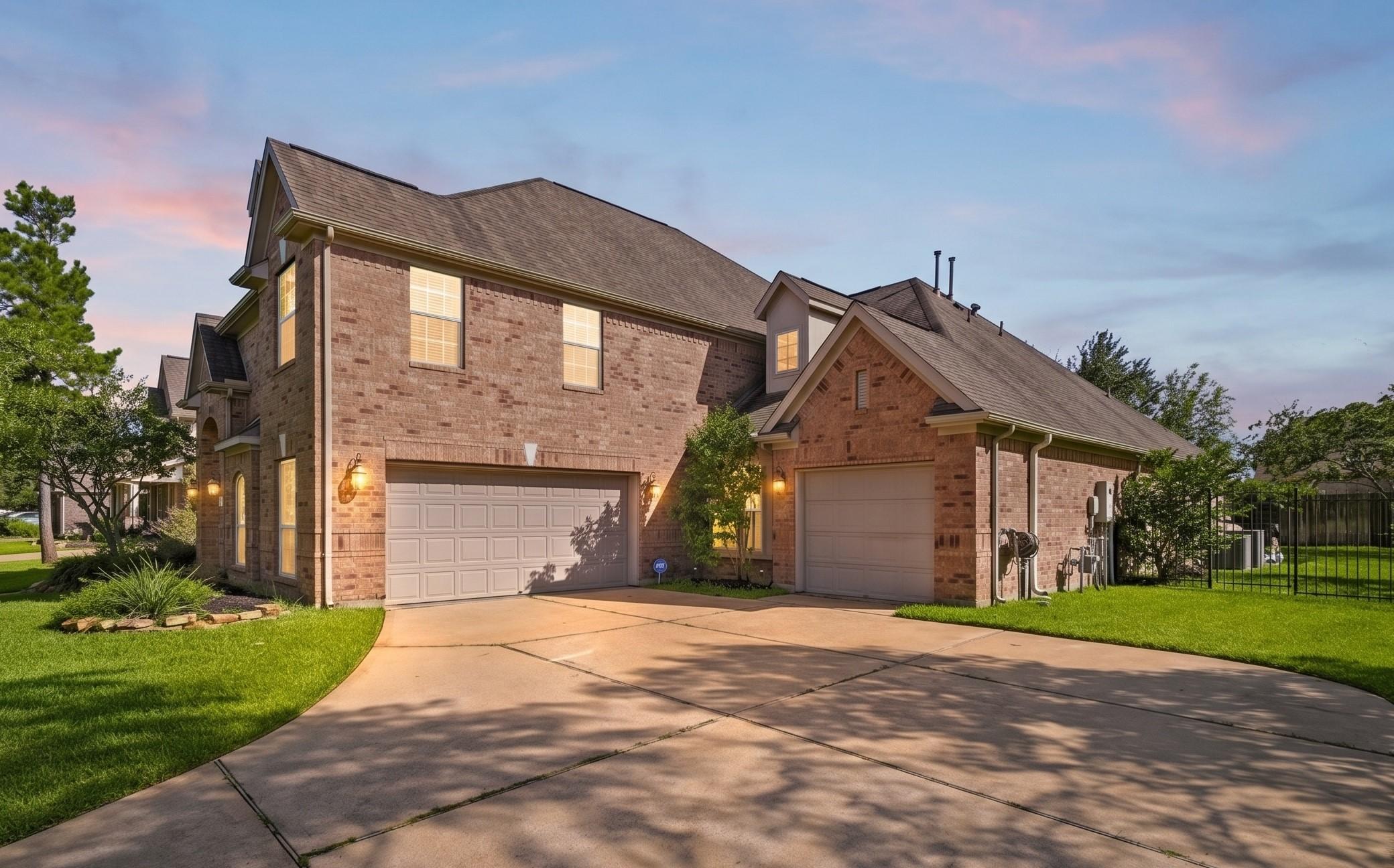 Image 3: Expansive driveway and desirable 3-car garage conf