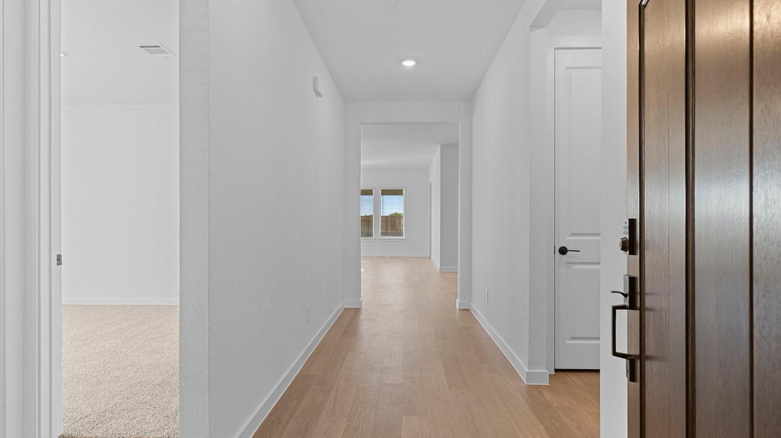 Image 3: Entry hallway leading to living room and kitchen i