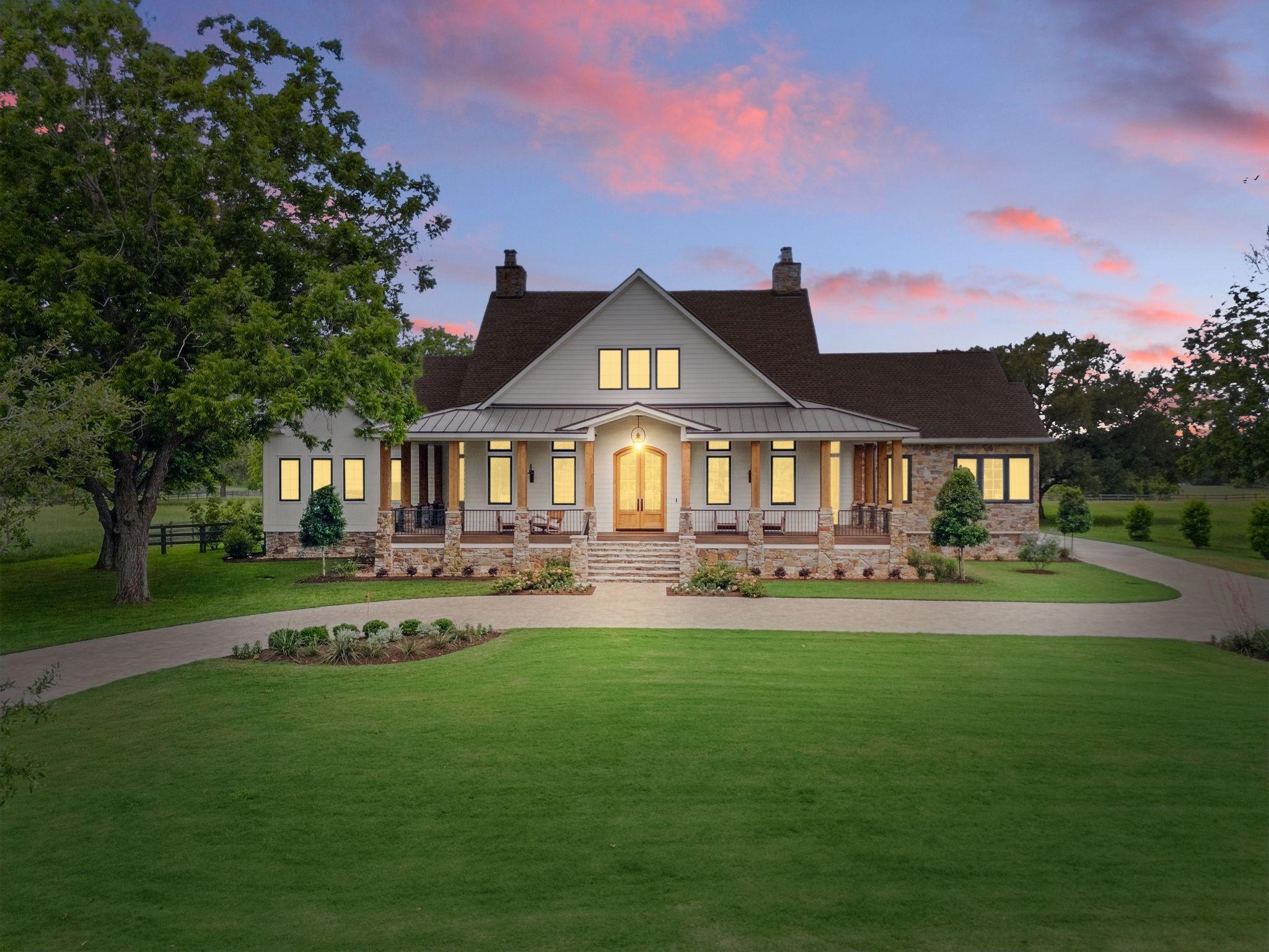 Image 1: This stunning home features a classic farmhouse de
