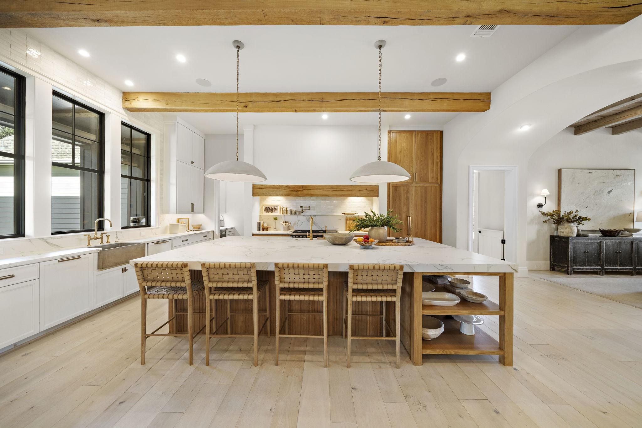 Image 4: This spacious kitchen features a large island with