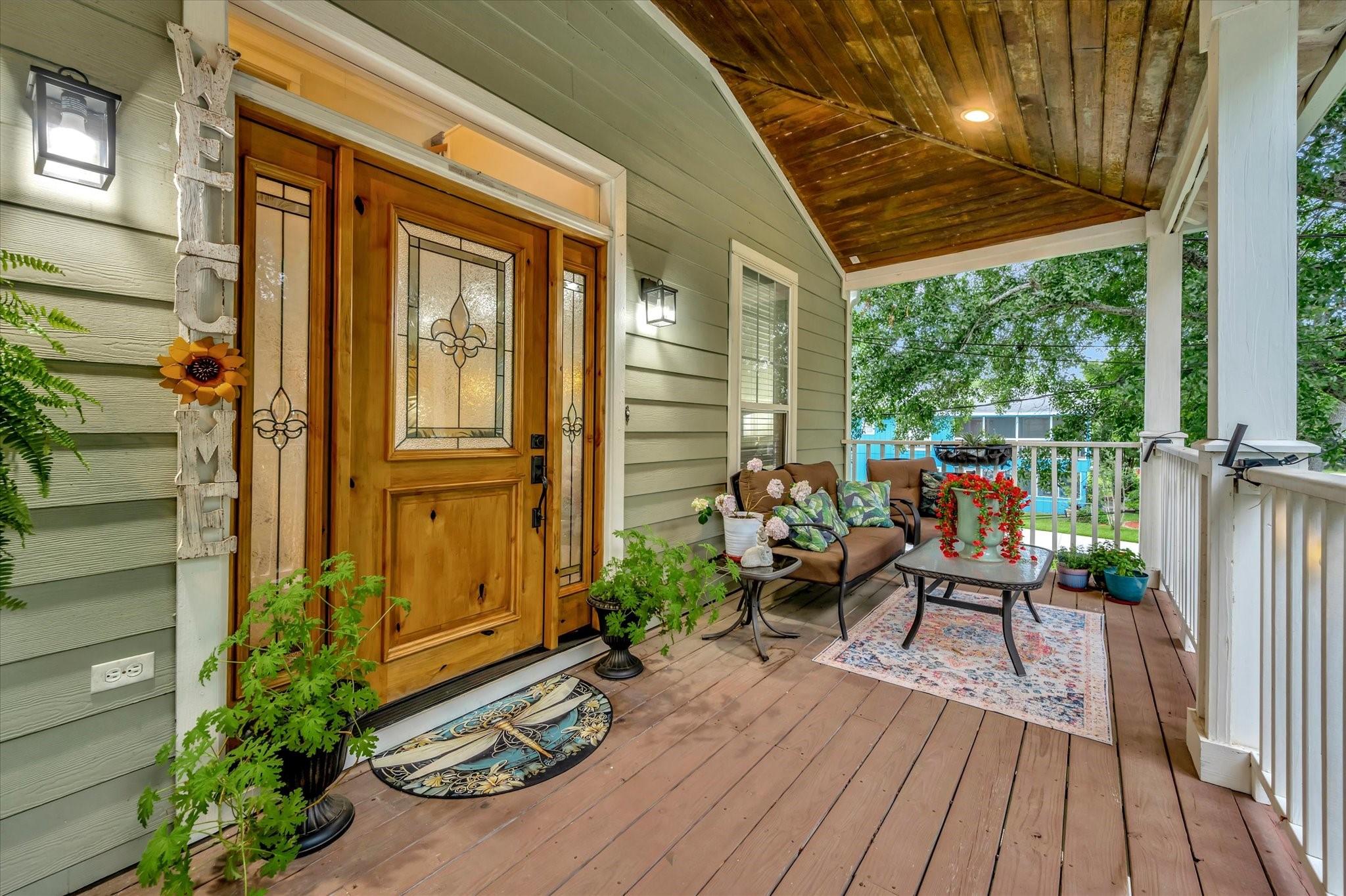Image 2: Welcoming front porch with a warm wooden door, dec