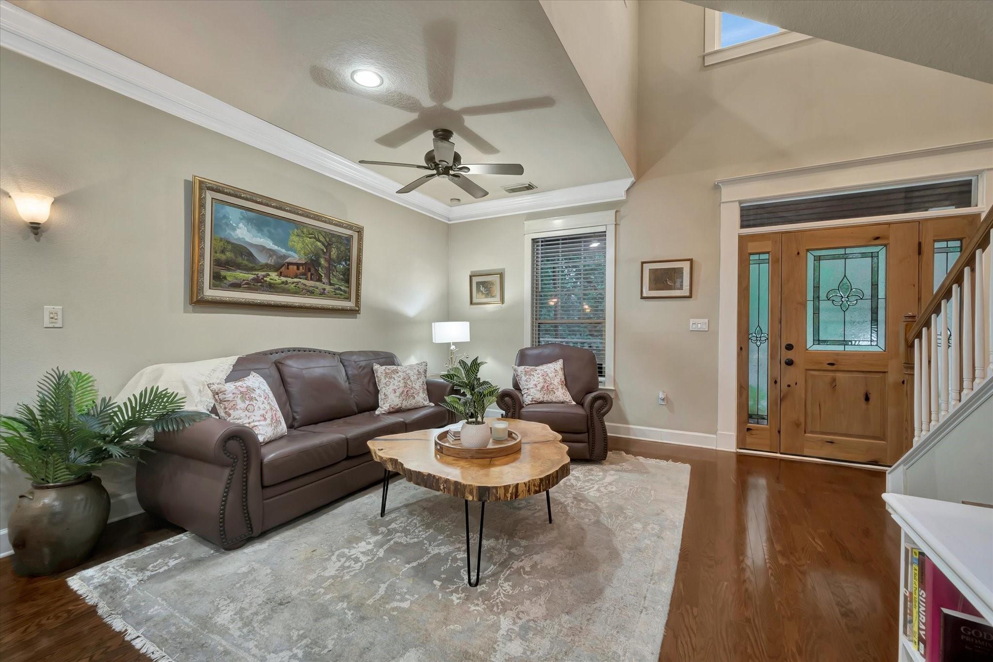 Image 4: An inviting living room with soaring ceilings, ric
