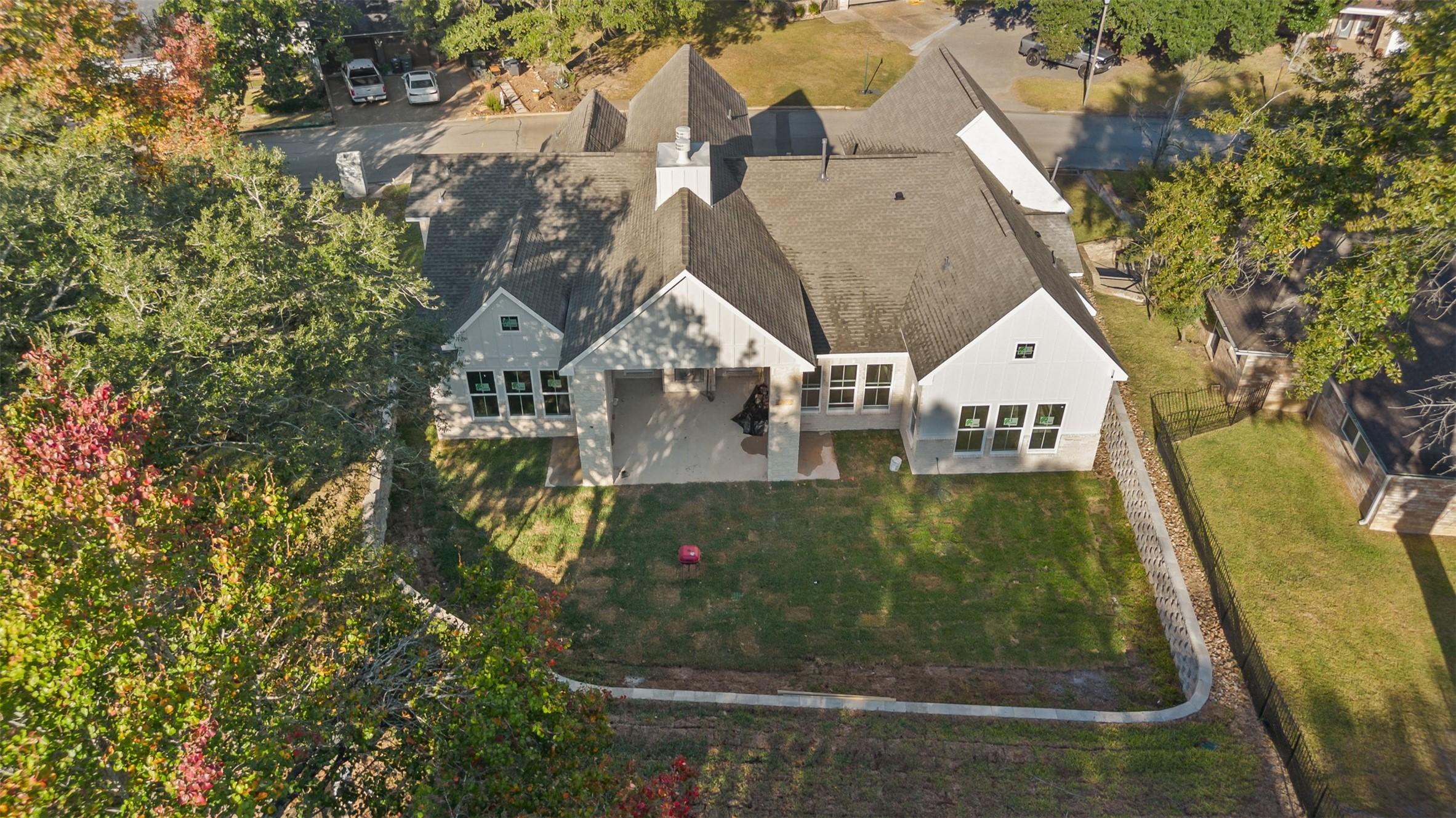 Image 1: Back view of home and lot
