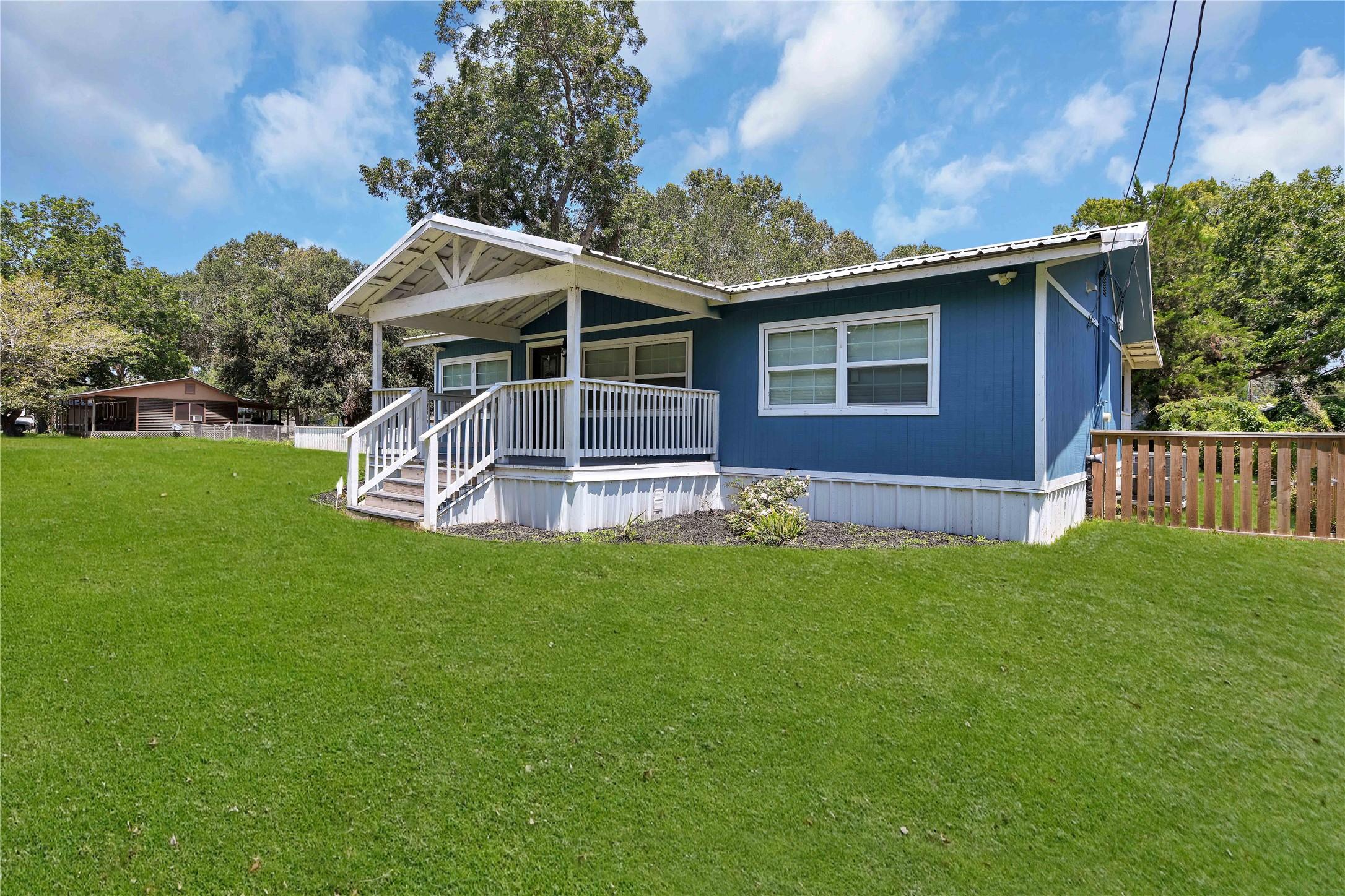 Image 3: Right side view of the home.