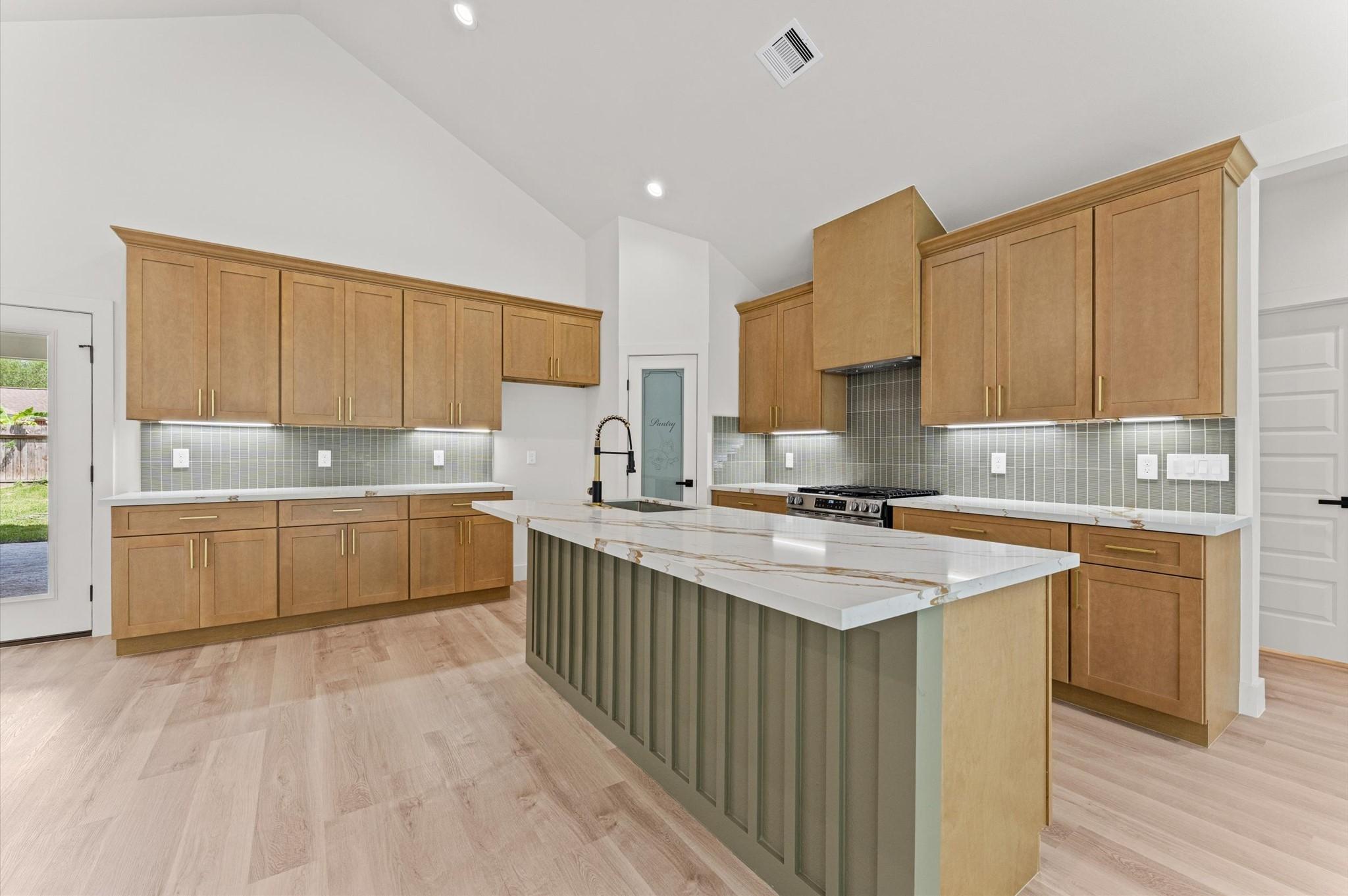 Image 2: The kitchen is equipped with a 5 burner gas range