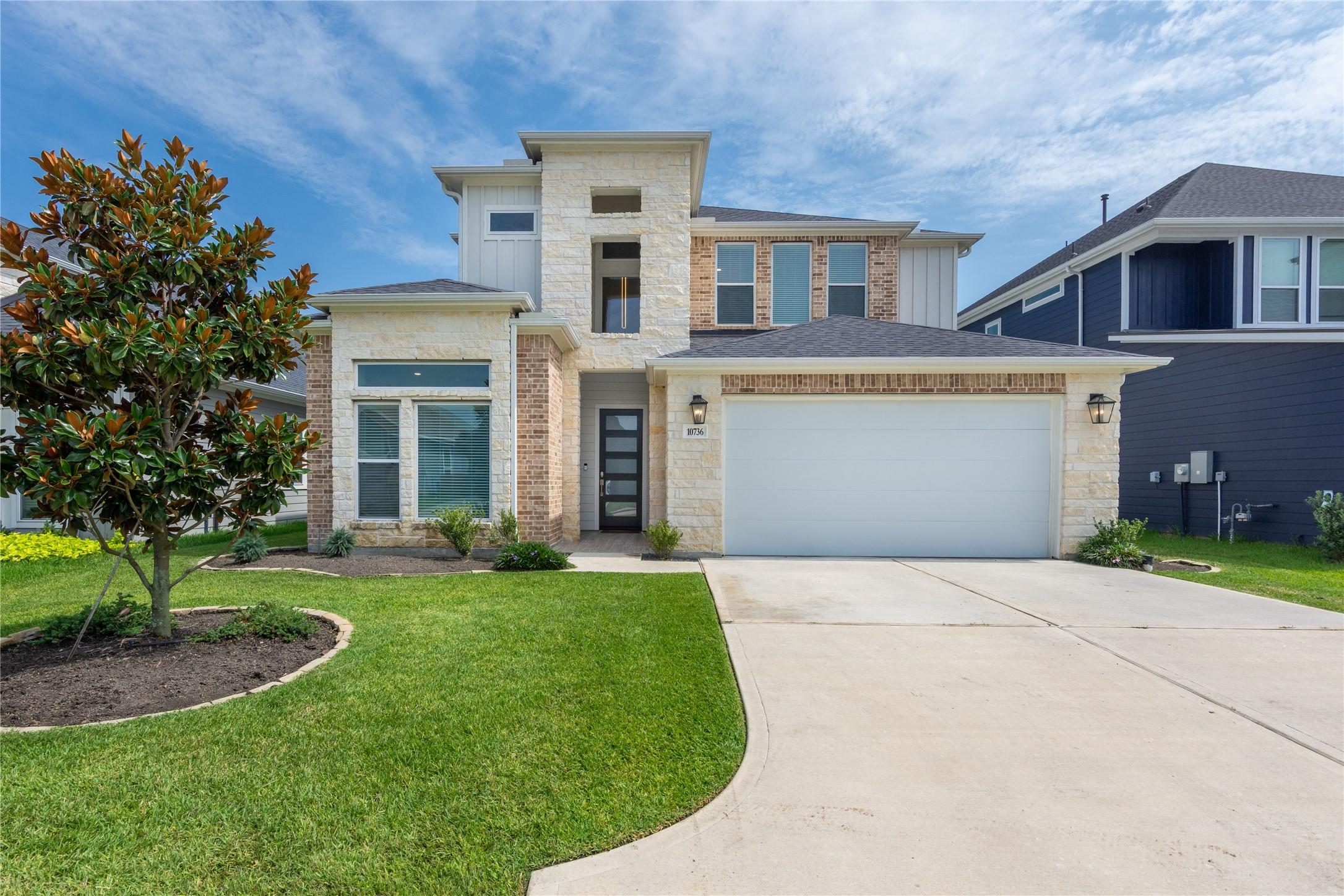 Image 1: A straight on view of the home's front facade show