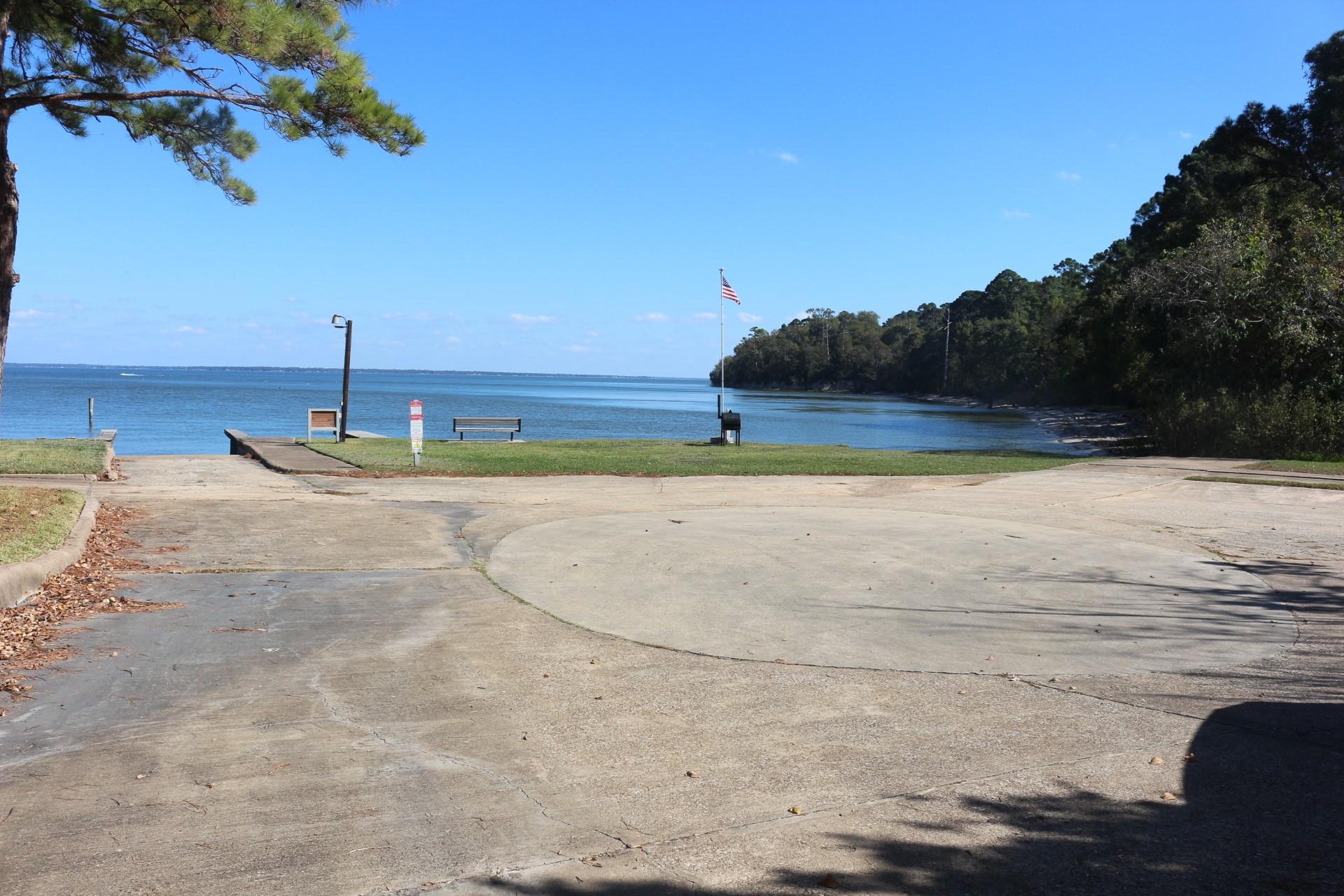 Image 3: Scenic waterfront view with a small boat ramp and