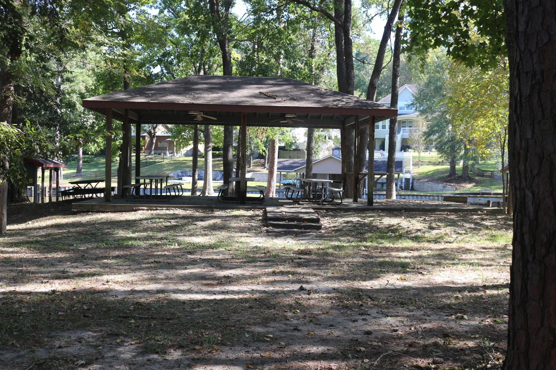 Image 4: This photo features a shaded pavilion with picnic