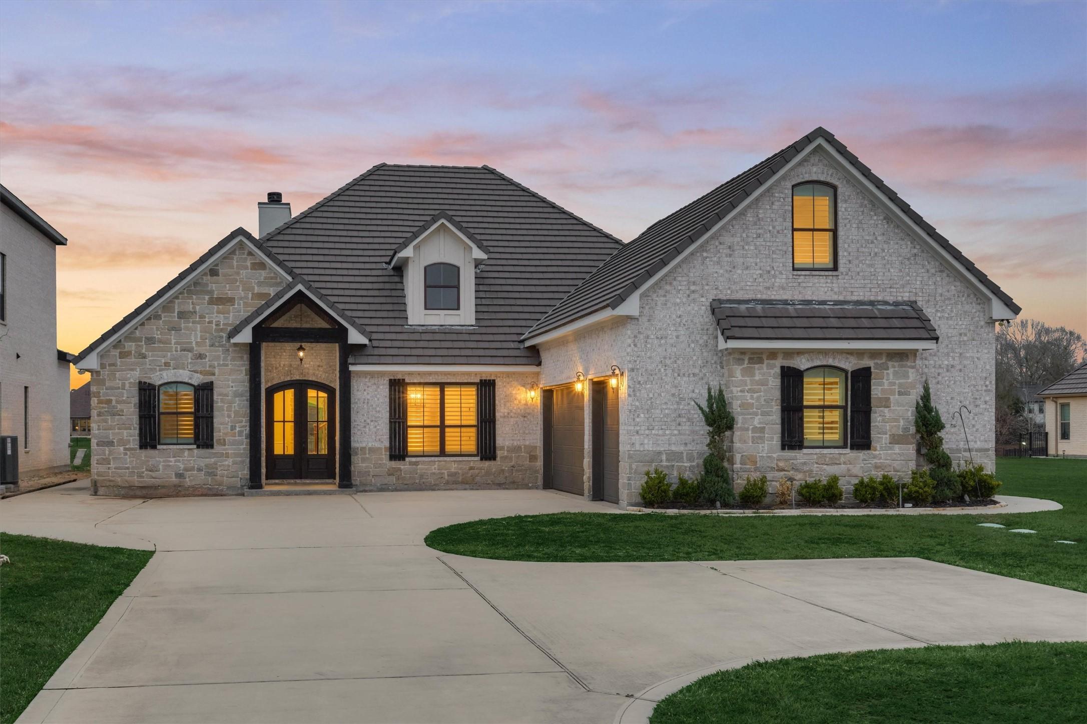 Image 3: The stunning front elevation showcases a beautiful