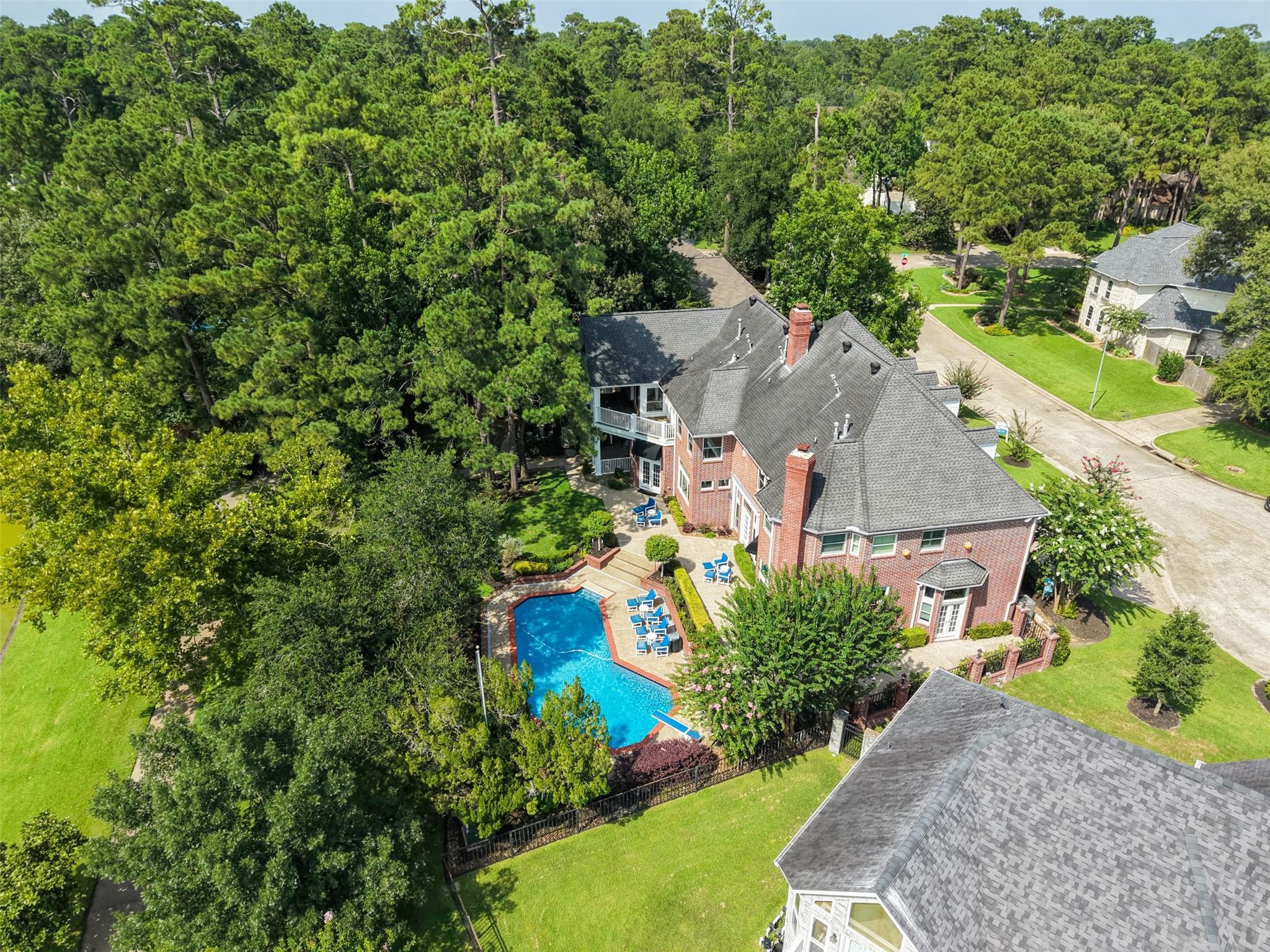 Image 4: Surrounded by mature trees and estate homes, this