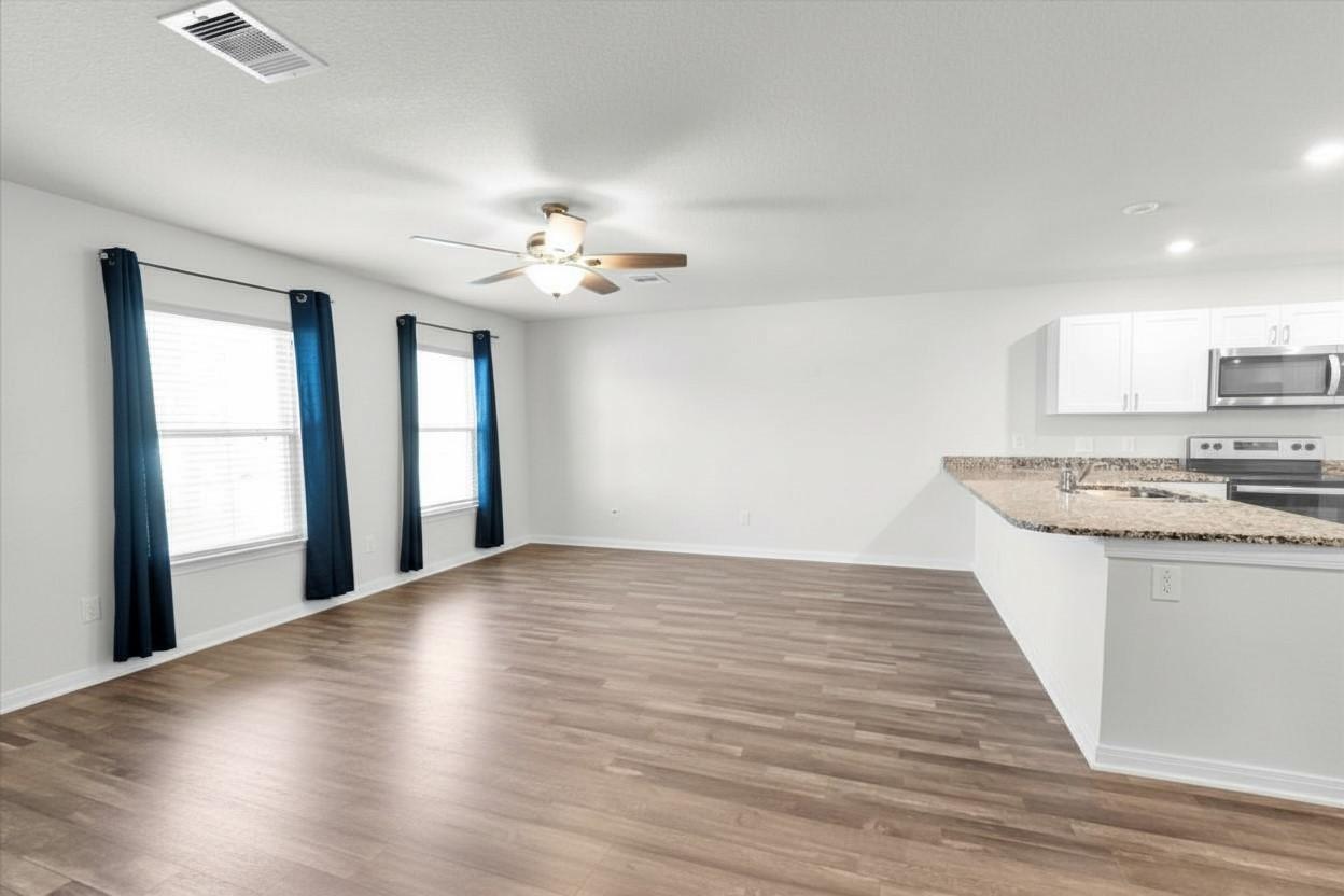 Image 2: Breakfast bar opens to living room.
