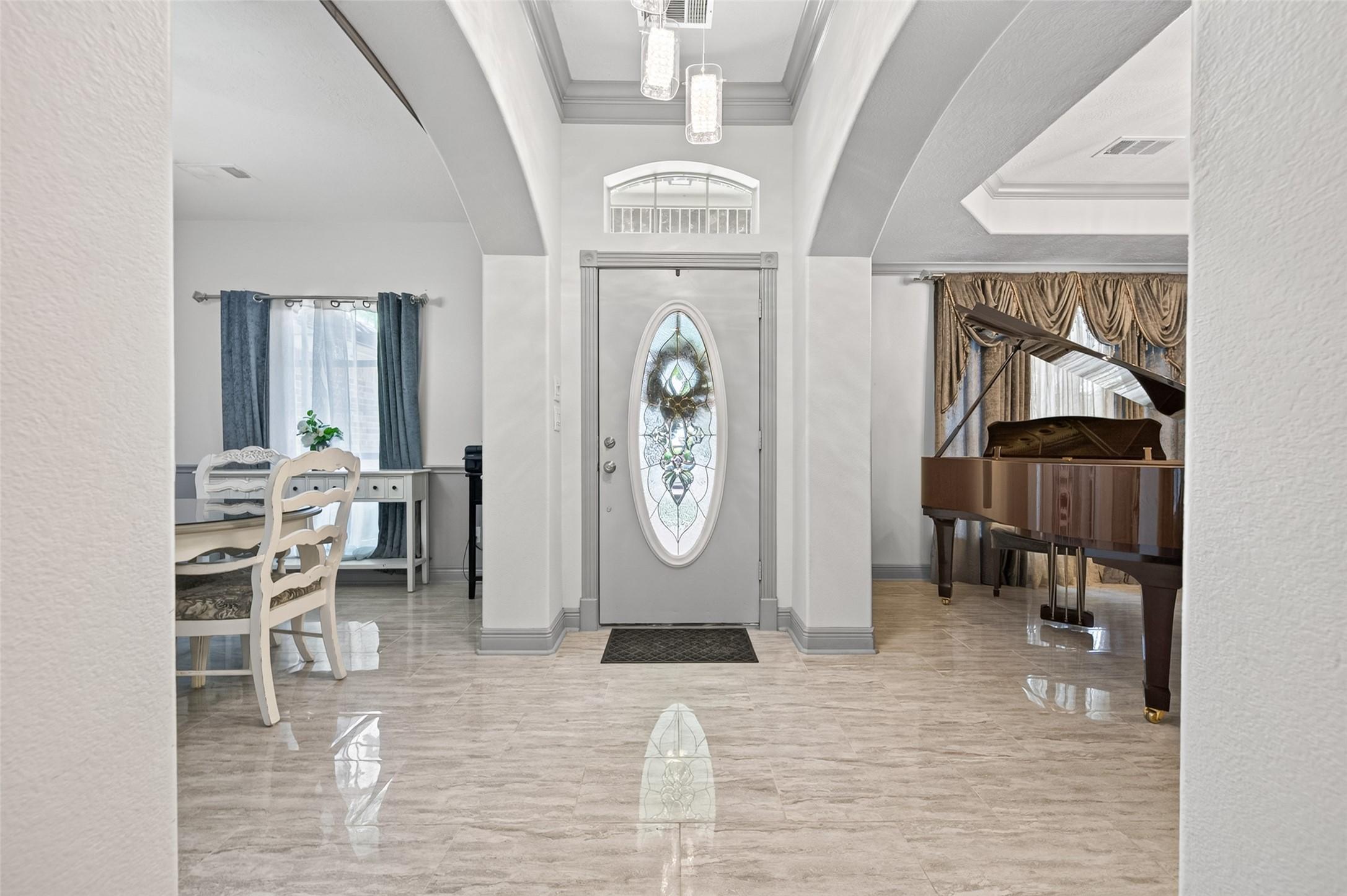 Image 2: Gorgeous entry flanked by formal living and dining